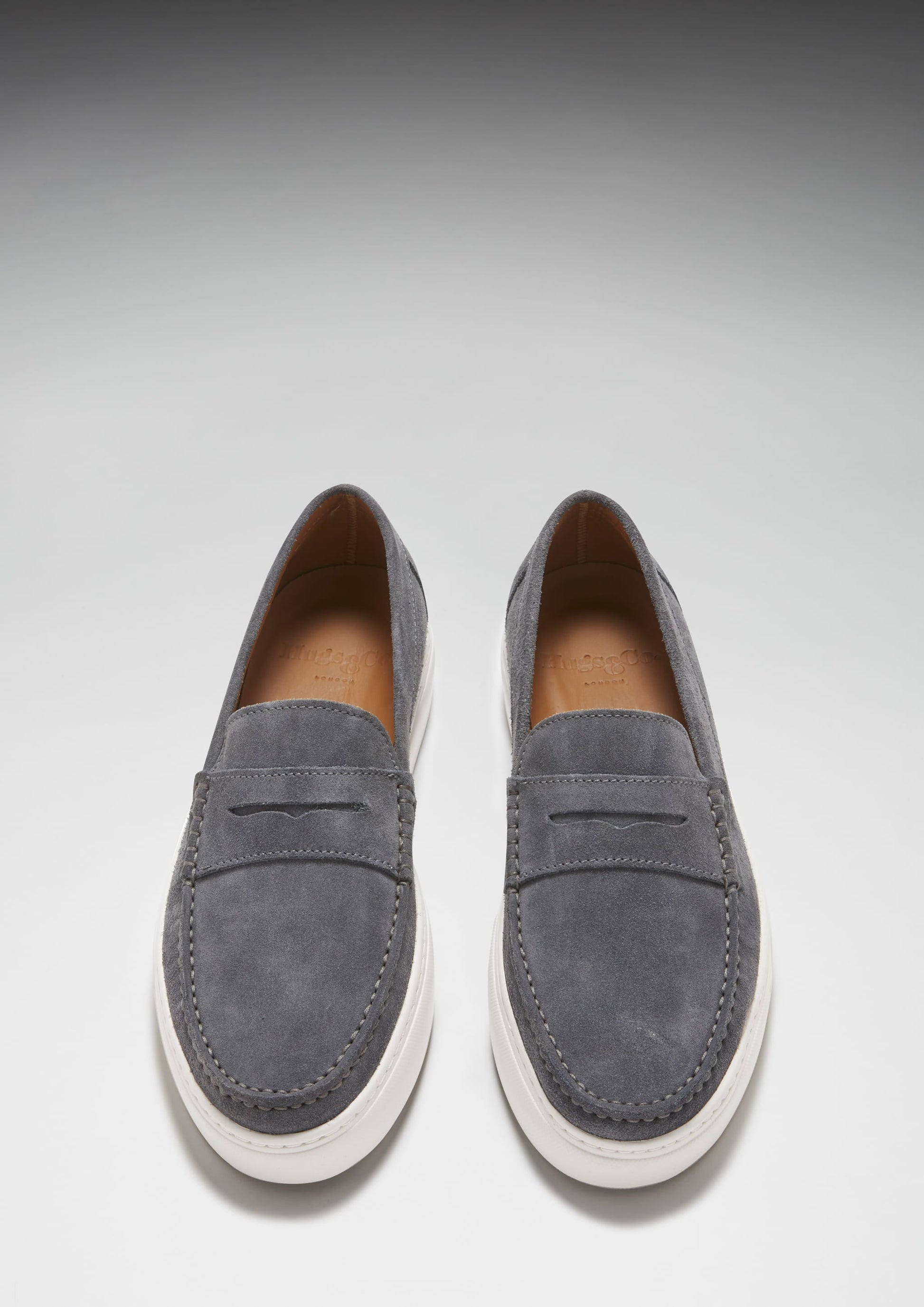 Pair of gray loafers on a light gray background
