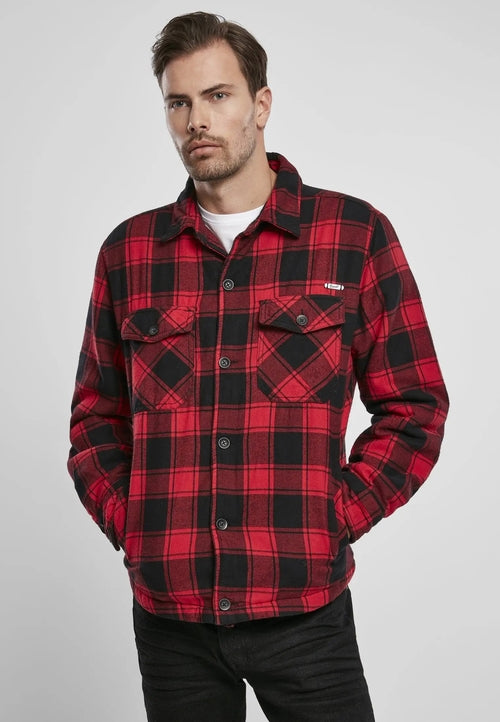 Man wearing a red and black plaid shirt on a gray background