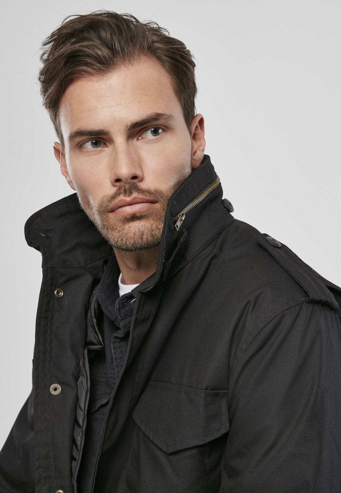 Man wearing a black jacket against a plain background
