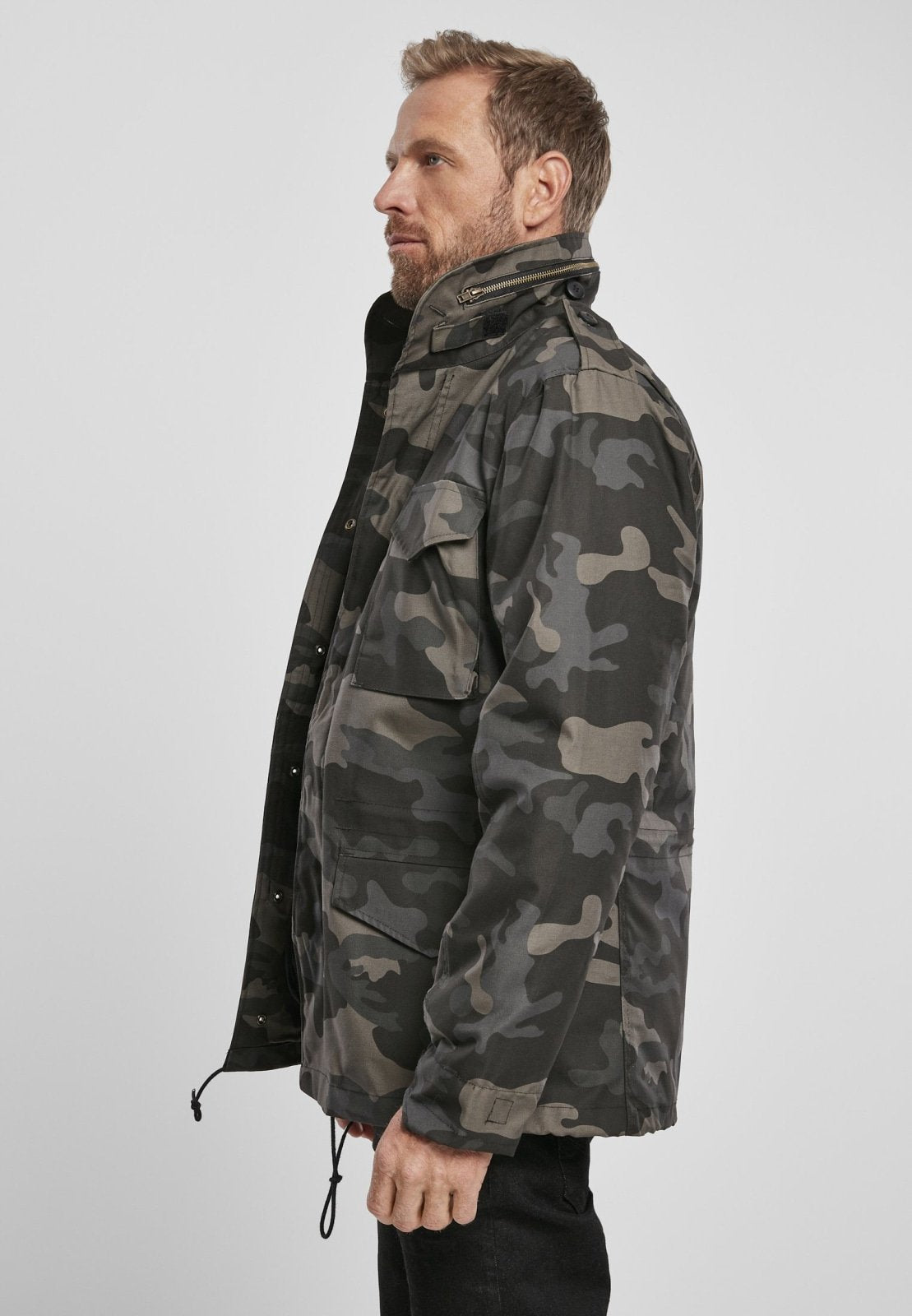 Man wearing a camouflage jacket on a white background