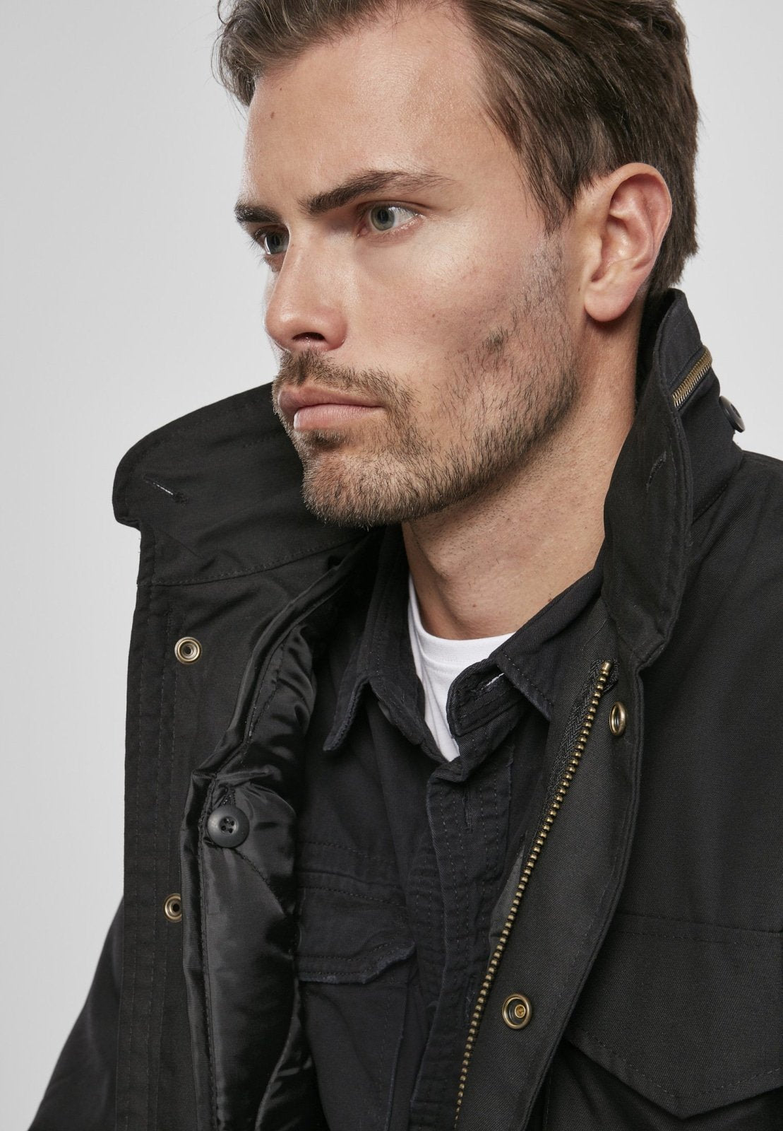 Man wearing a black jacket against a plain background
