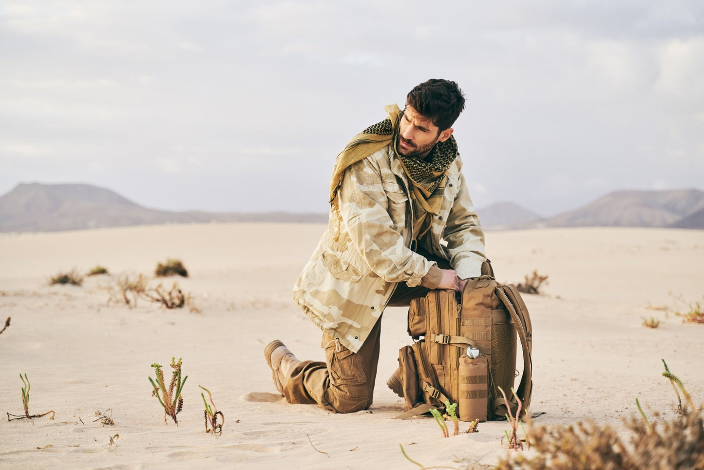 Man in desert setting with a backpack