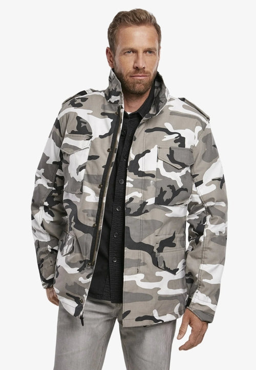 Man wearing a camouflage jacket on a white background