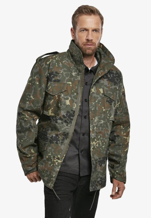Man wearing a camouflage jacket on a white background