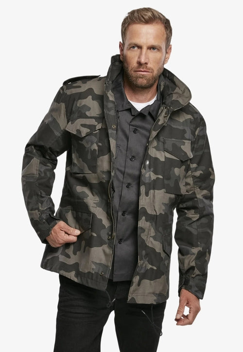 Man wearing a camouflage jacket on a white background