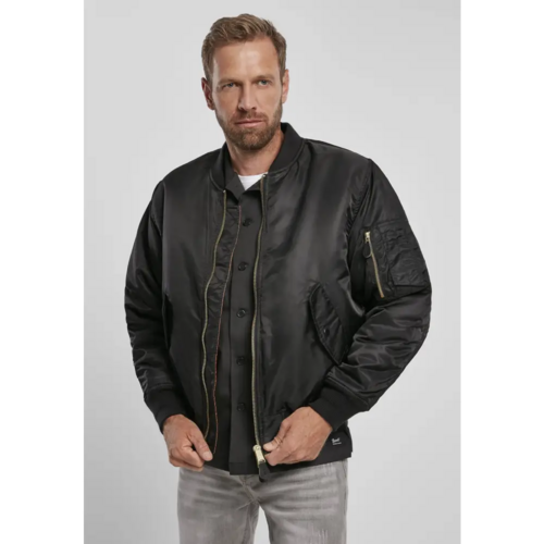 Man wearing a black jacket on a light gray background