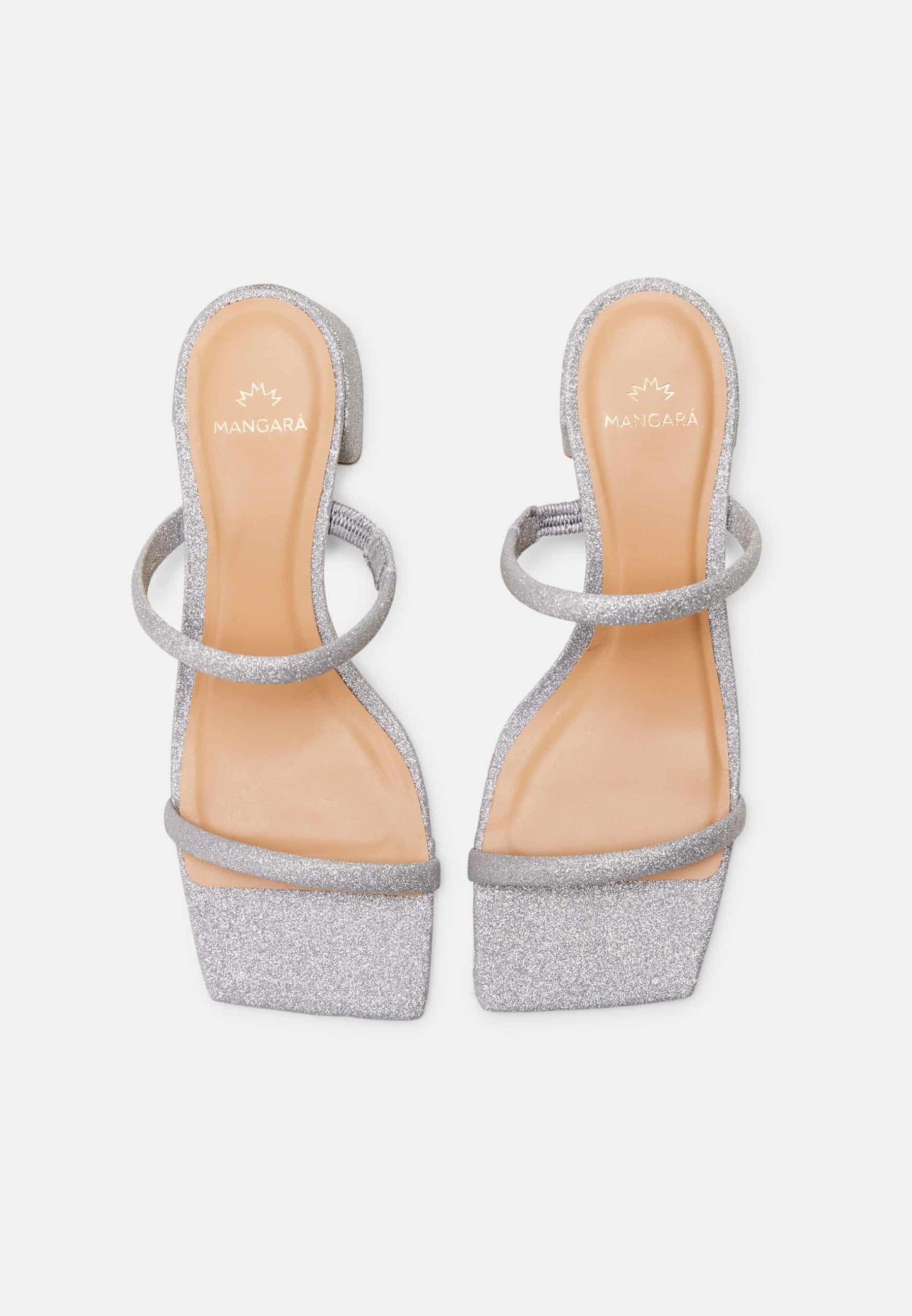 Pair of silver glitter high-heeled sandals on a light gray background