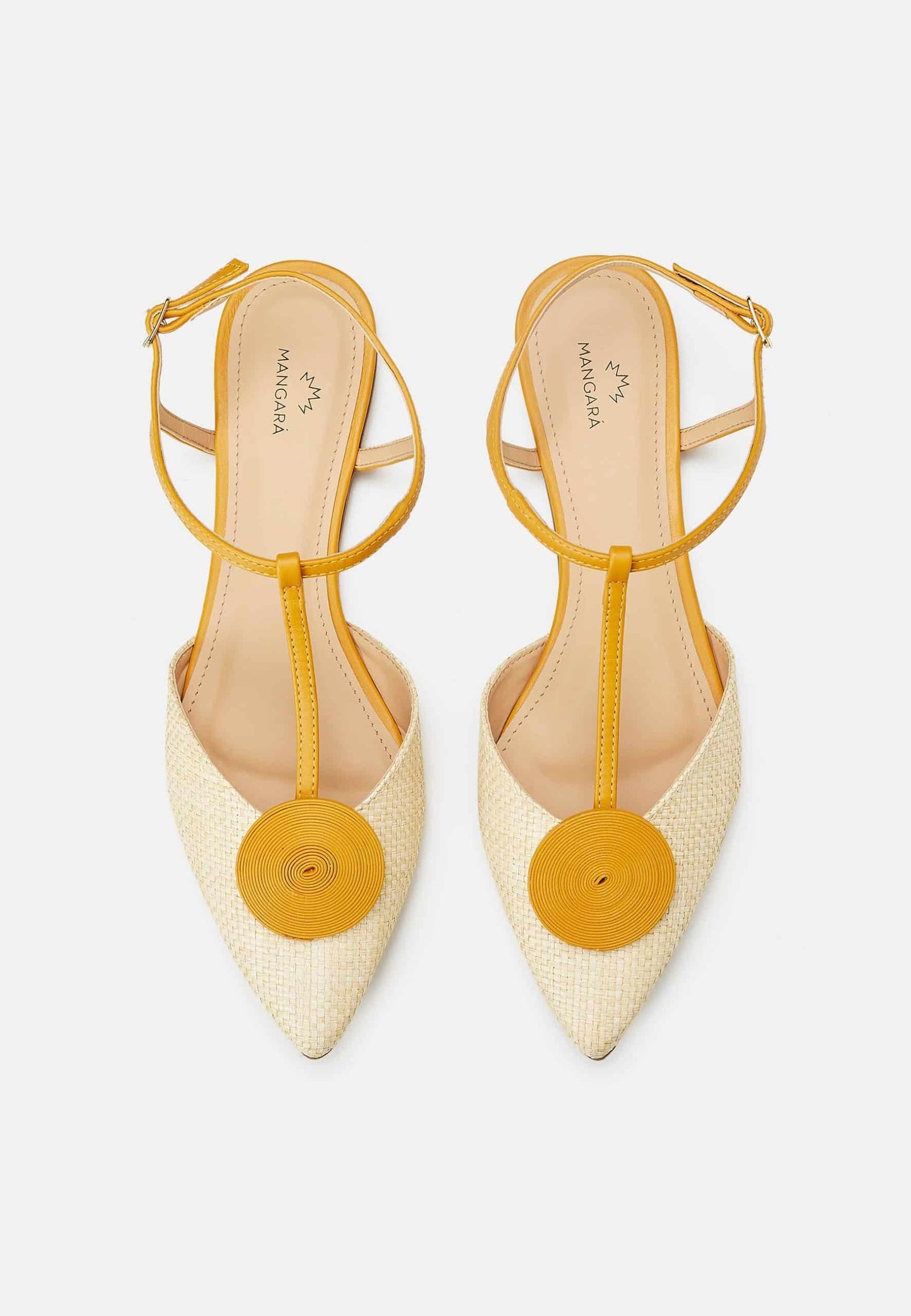 Pair of pointed-toe shoes with yellow straps and circular accents on a light gray background