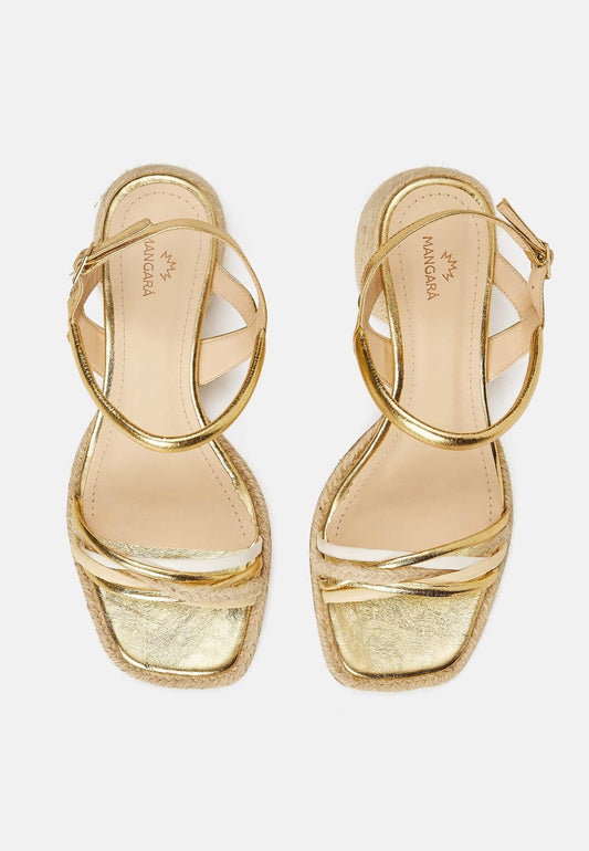 Gold high-heeled sandals on a white background