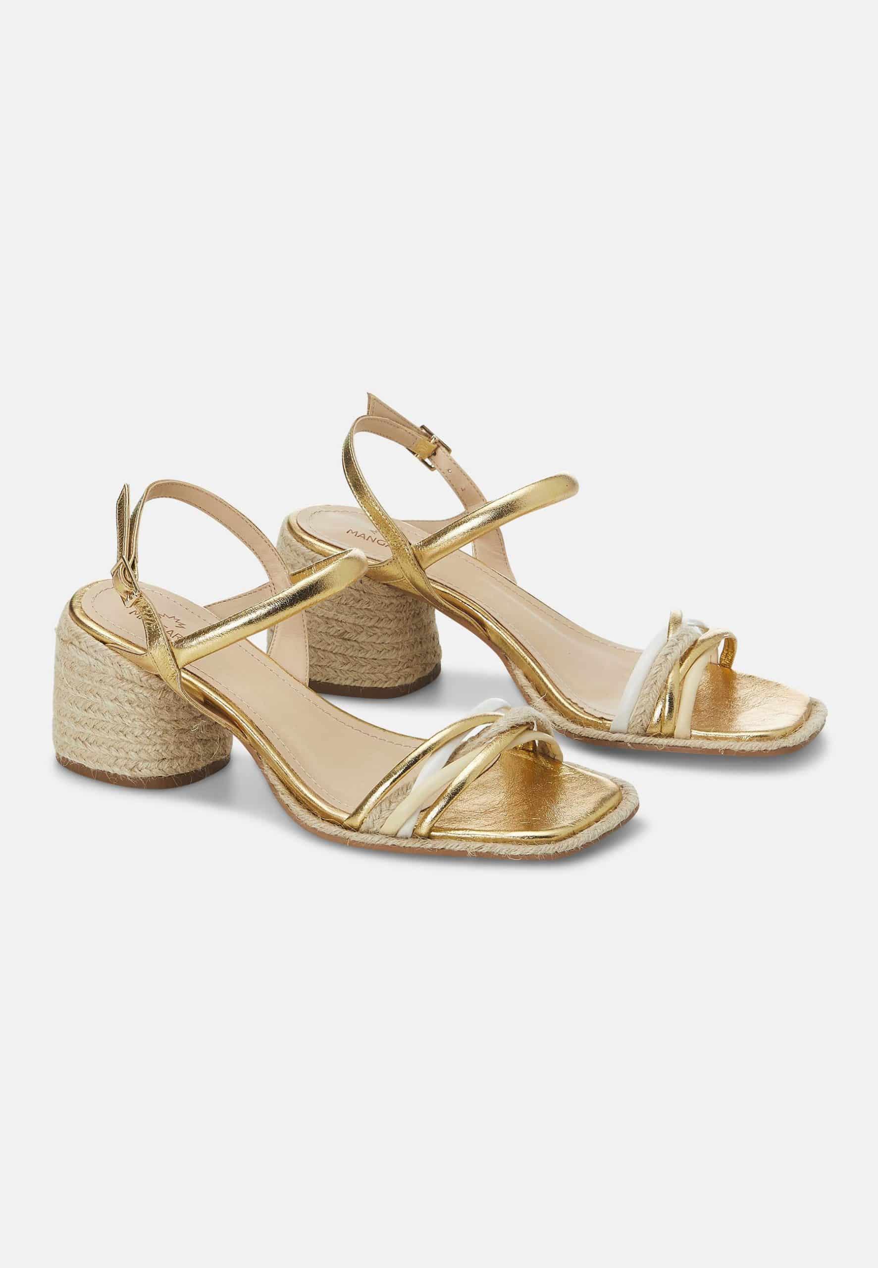 Gold sandals with jute block heels on a white background