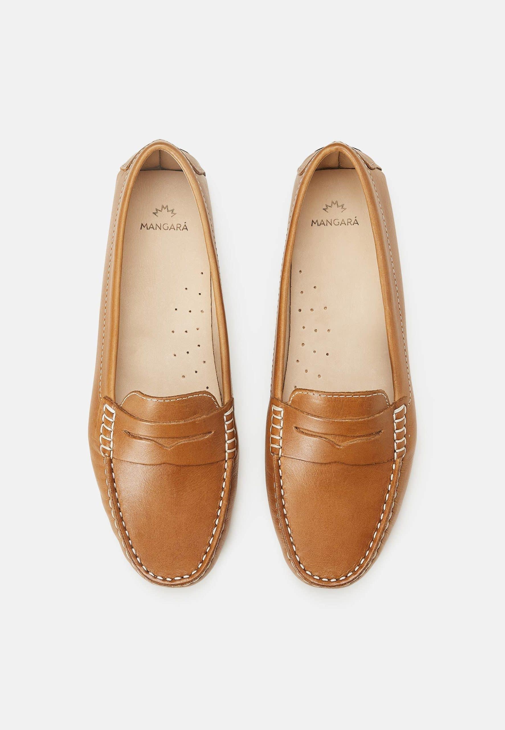 Pair of tan loafers on a white background