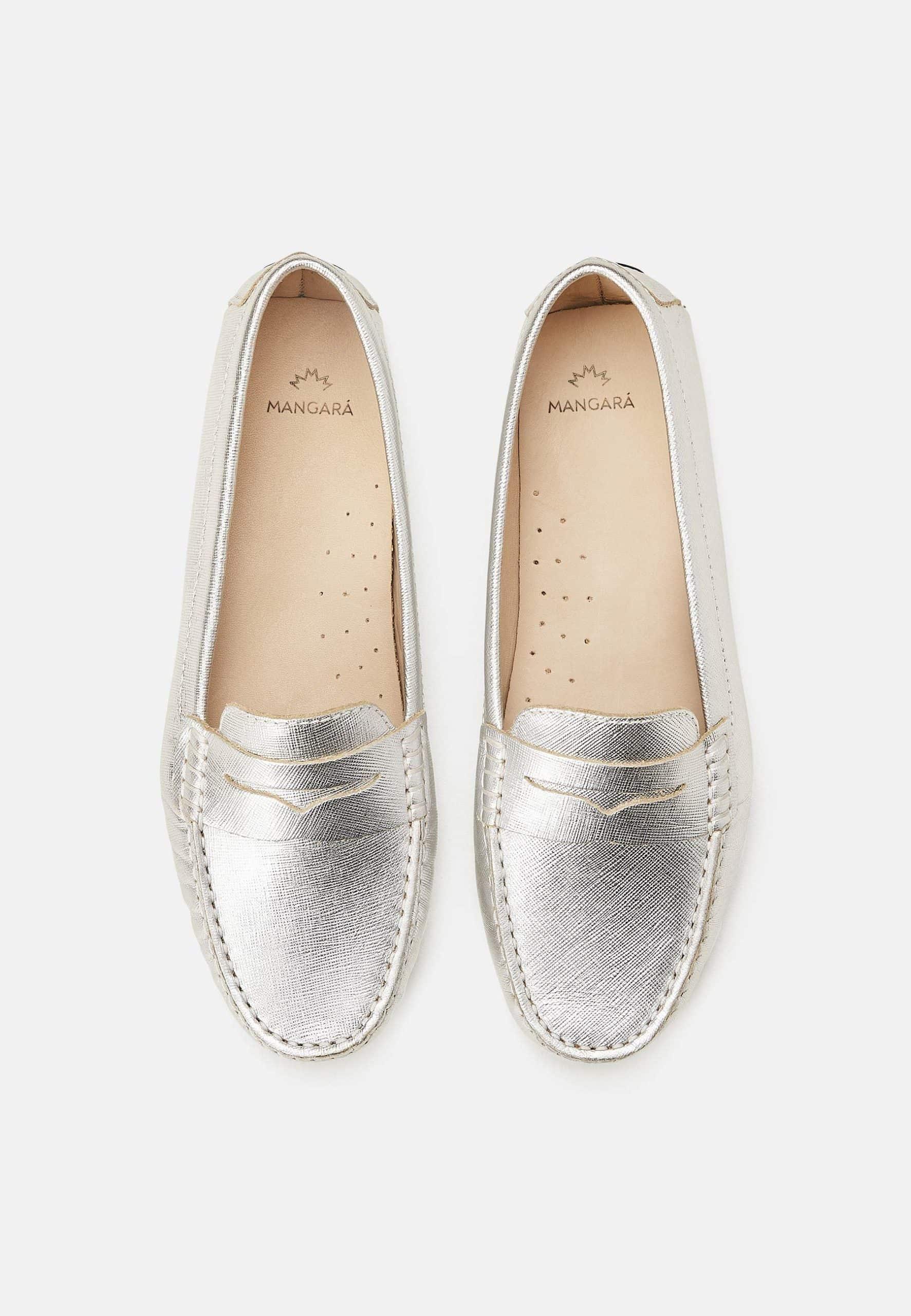 Pair of silver loafers on a white background