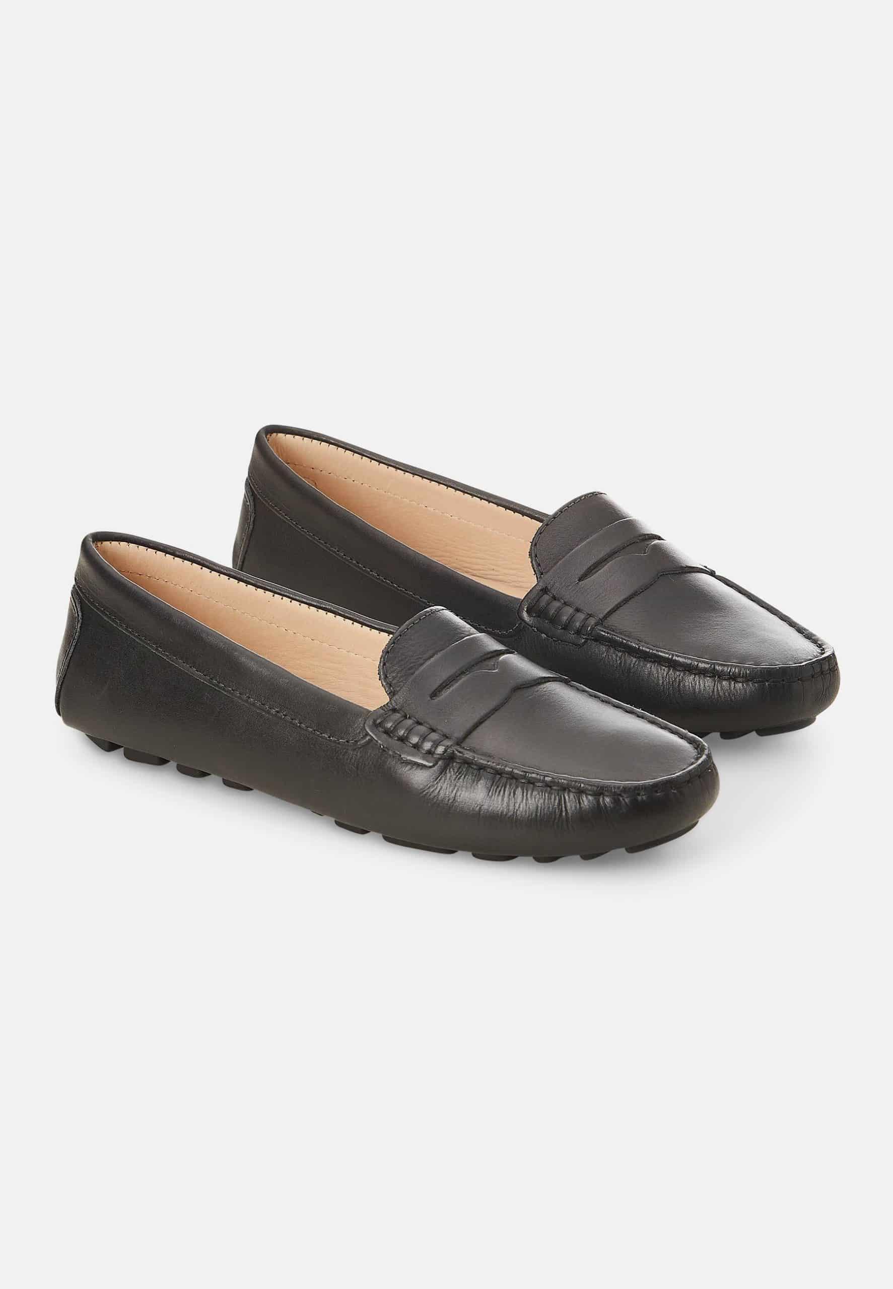 Pair of black loafers on a light gray background