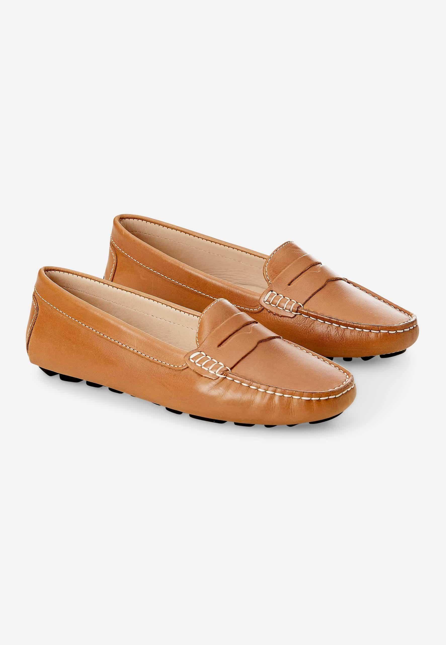 Pair of tan loafers on a white background