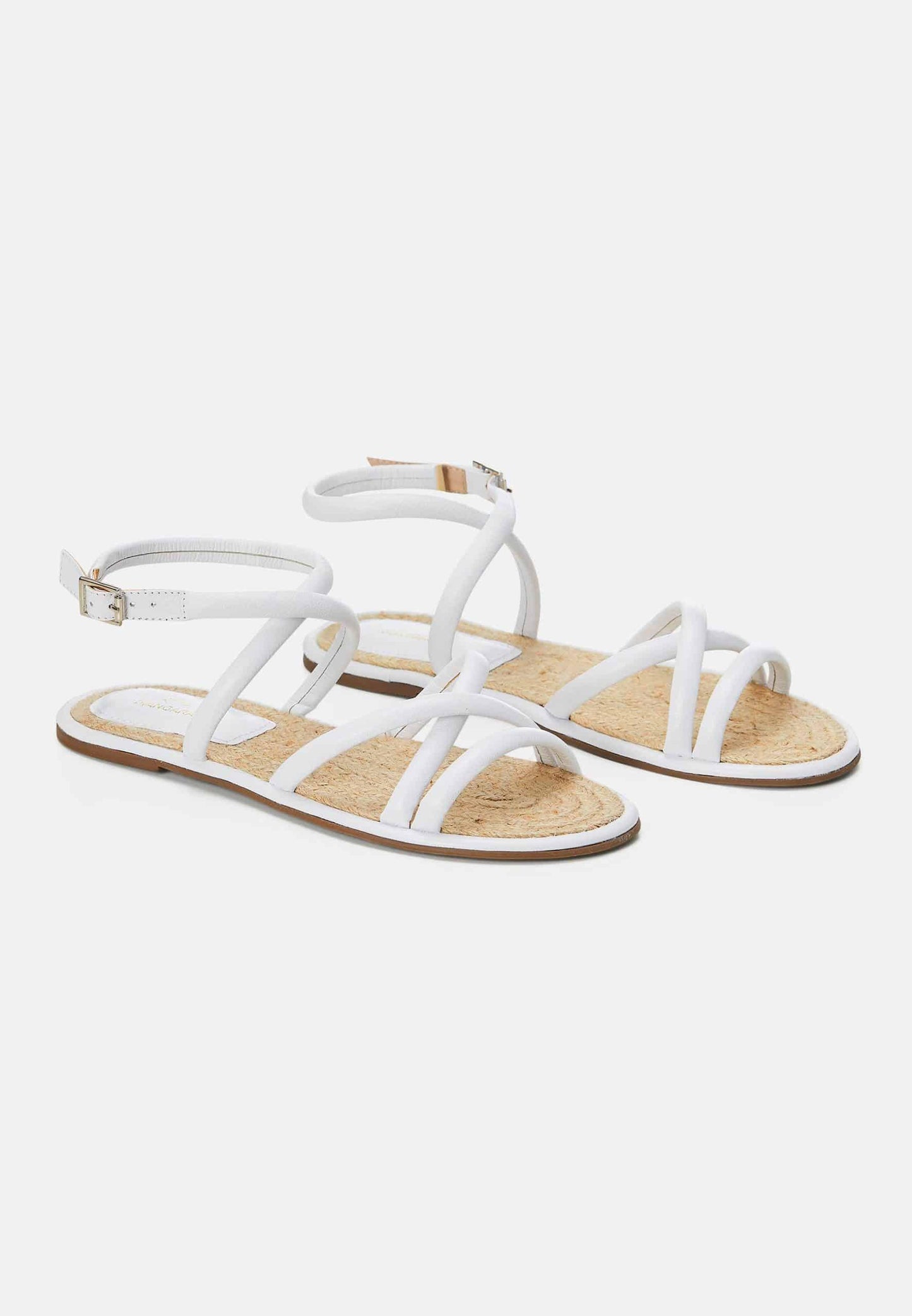 Pair of white sandals on a light beige background