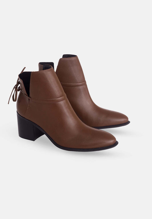 Pair of brown ankle boots with black soles on a white background