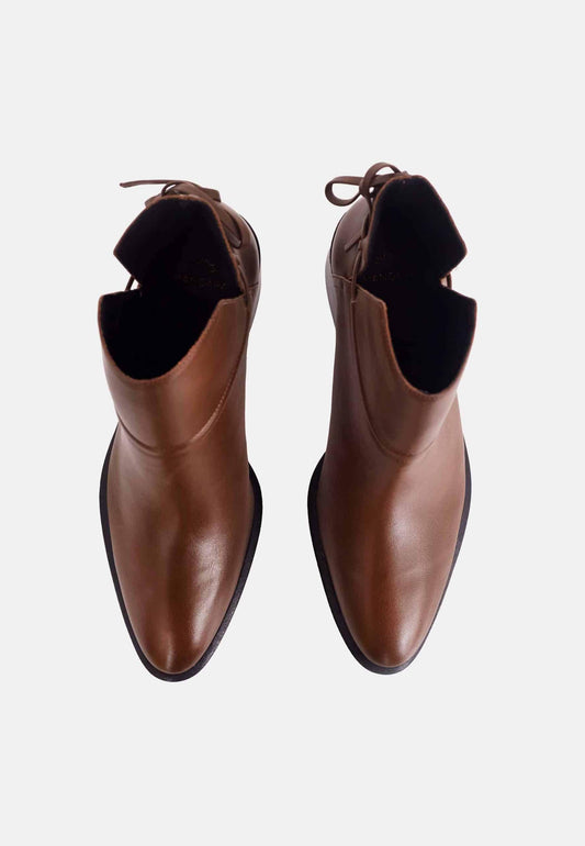 Pair of brown leather ankle boots on a white background