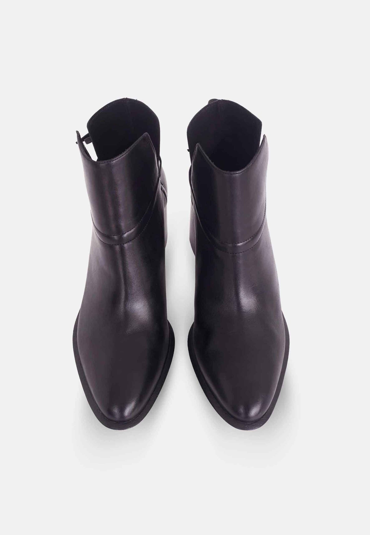 Pair of black leather ankle boots on a white background