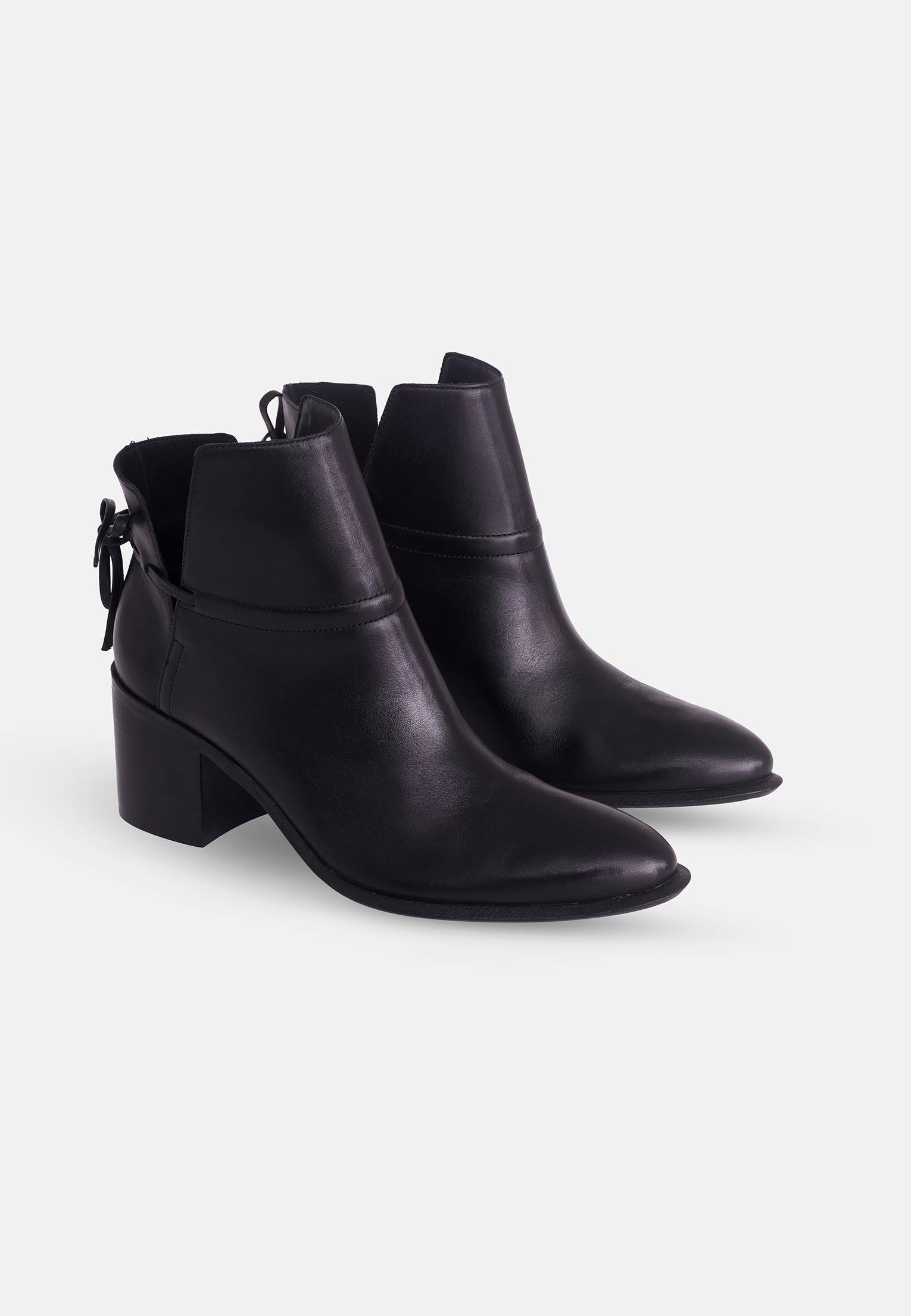 Pair of black ankle boots on a white background