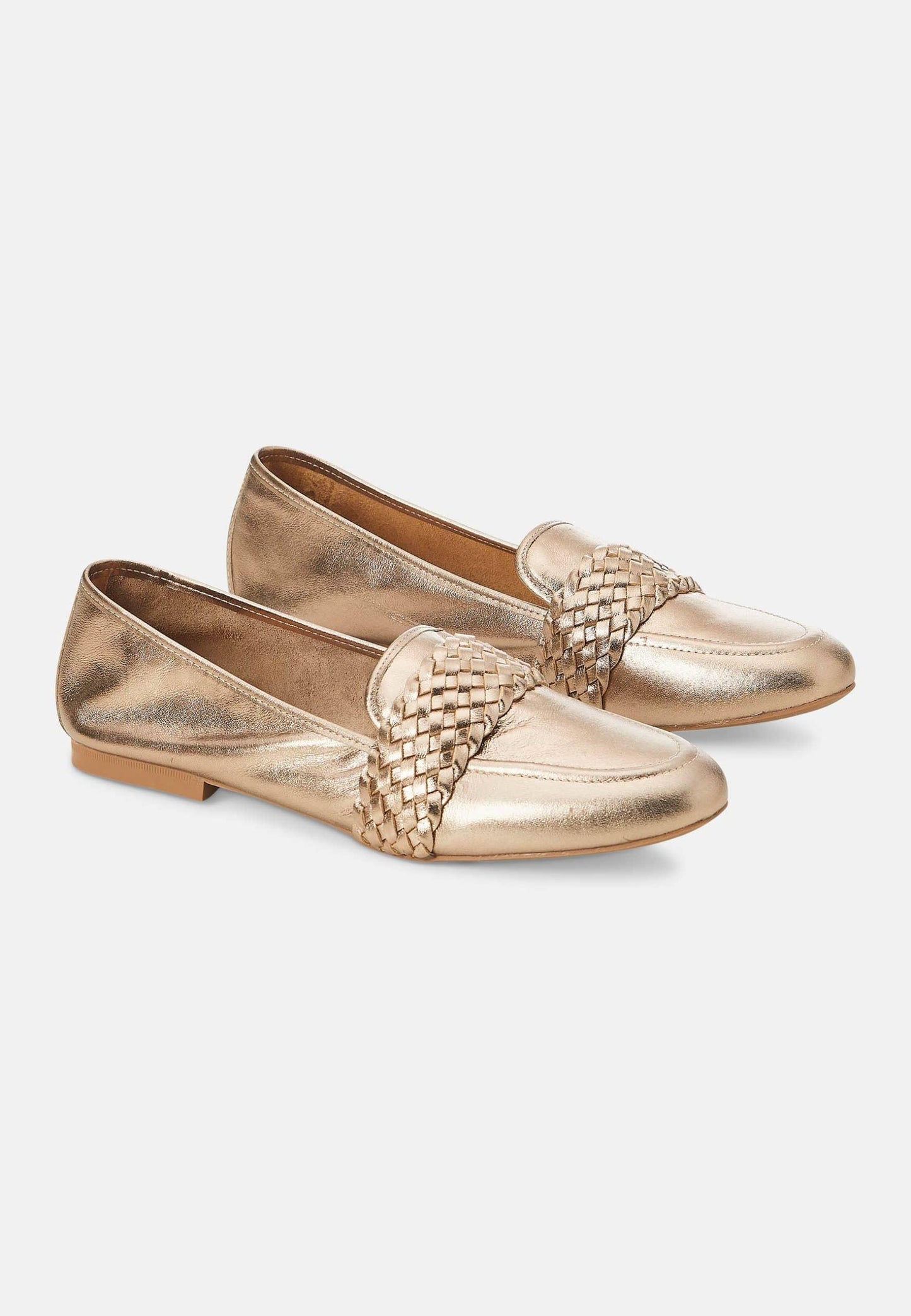 Pair of gold loafers with woven detail on a white background