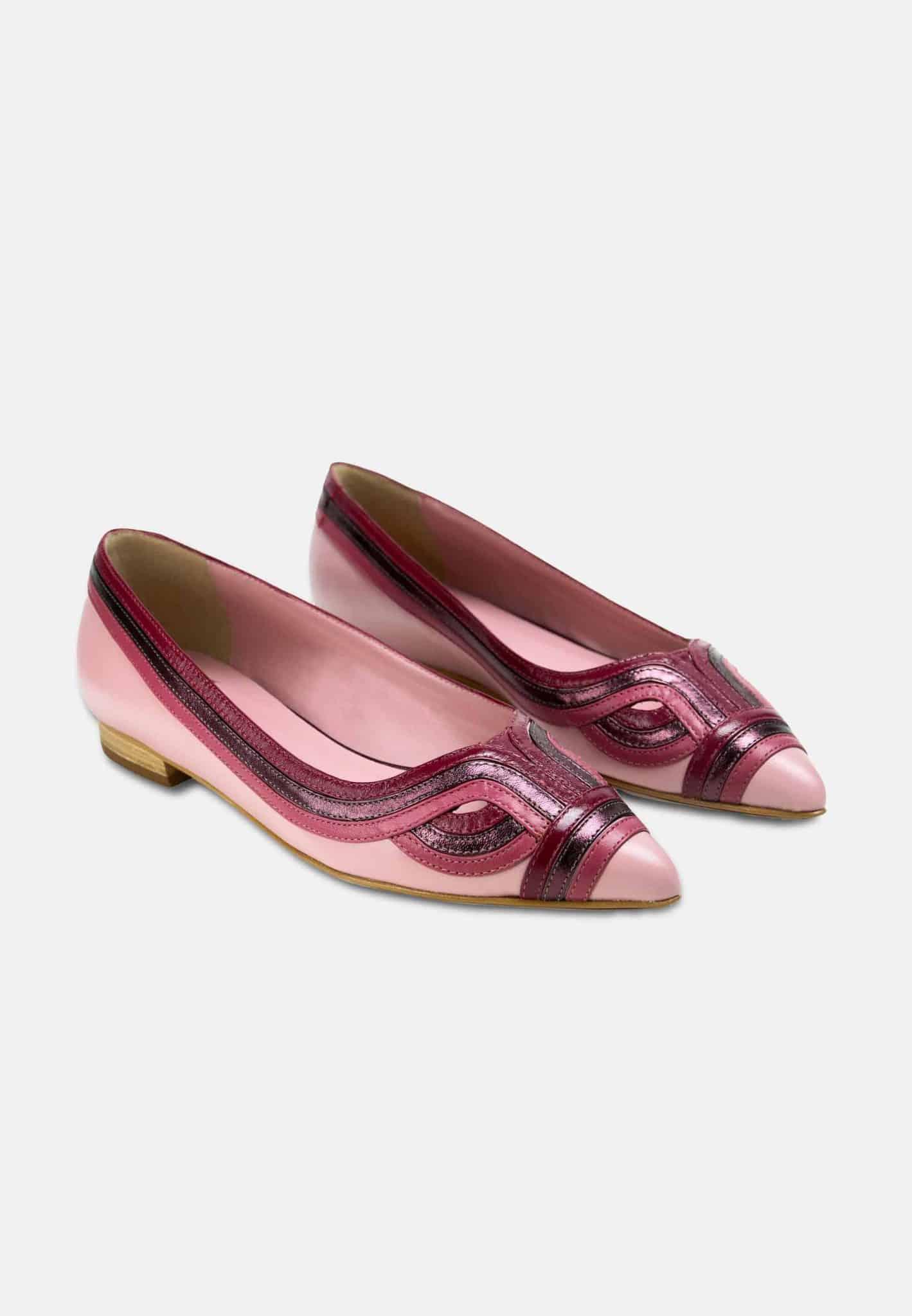 Pair of pink and red patent leather shoes on a white background