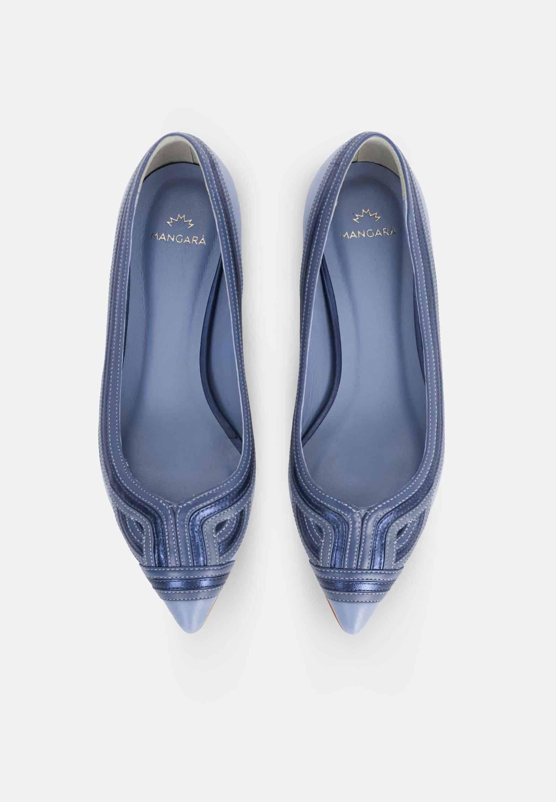 Pair of blue pointed-toe flats on a white background