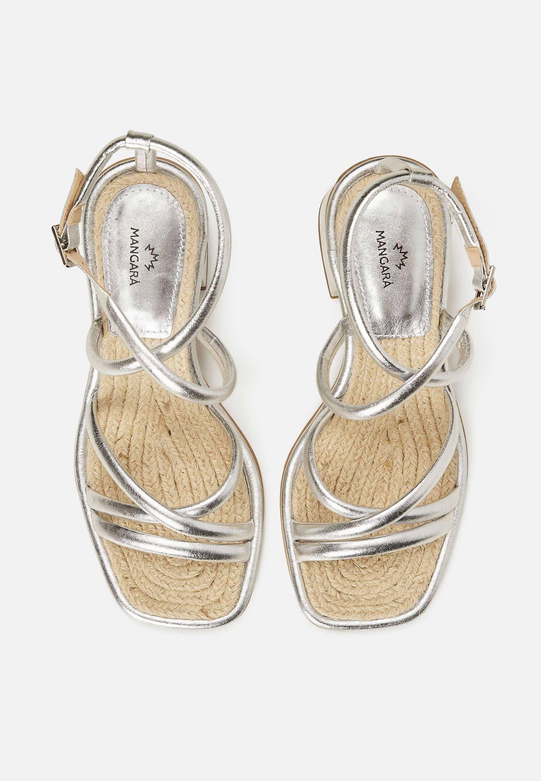 Silver strappy sandals with jute sole on a white background