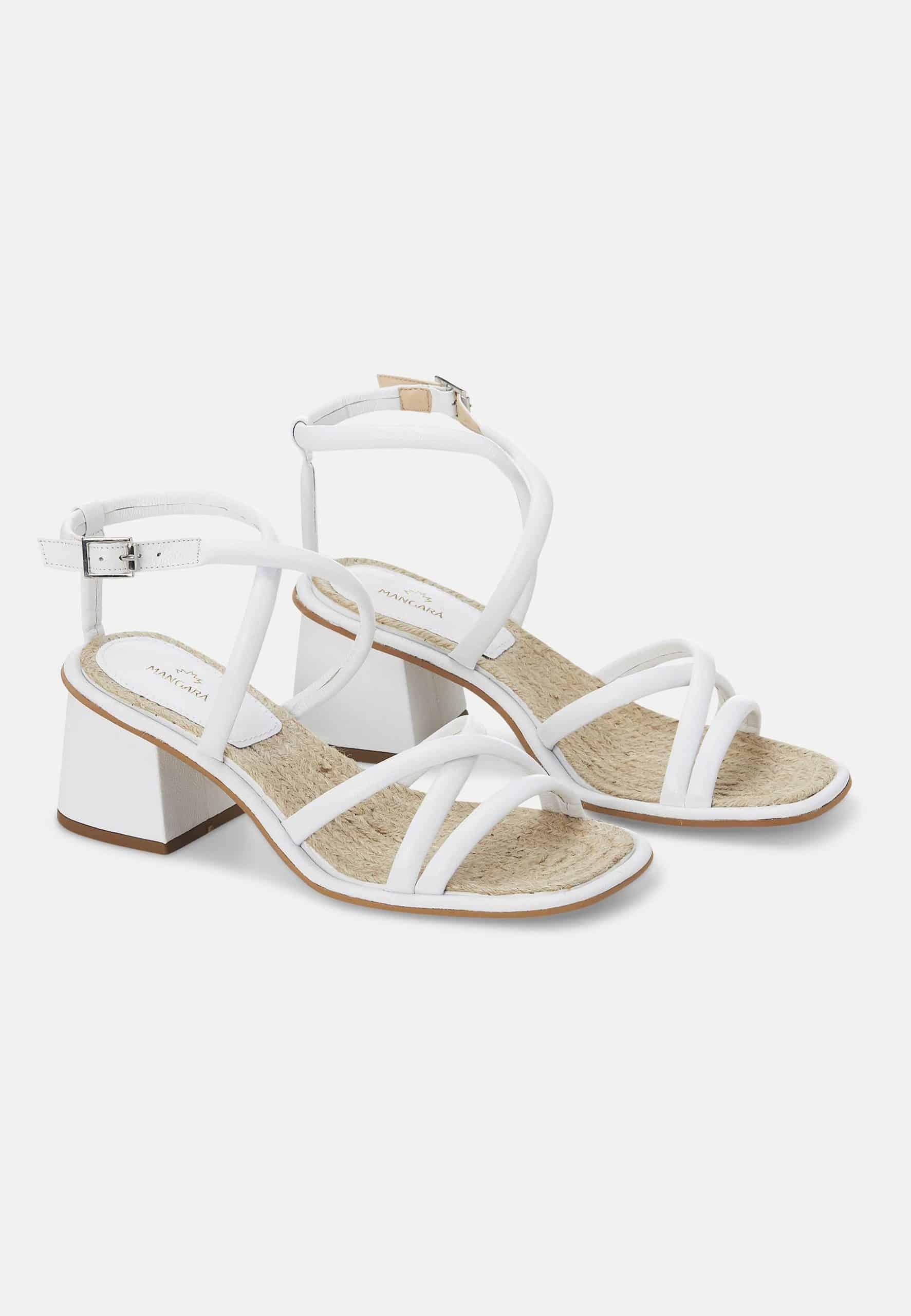 White sandals with a block heel on a white background