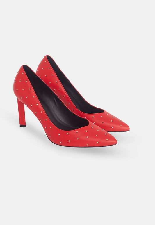 Red high-heeled shoes with black soles on a white background