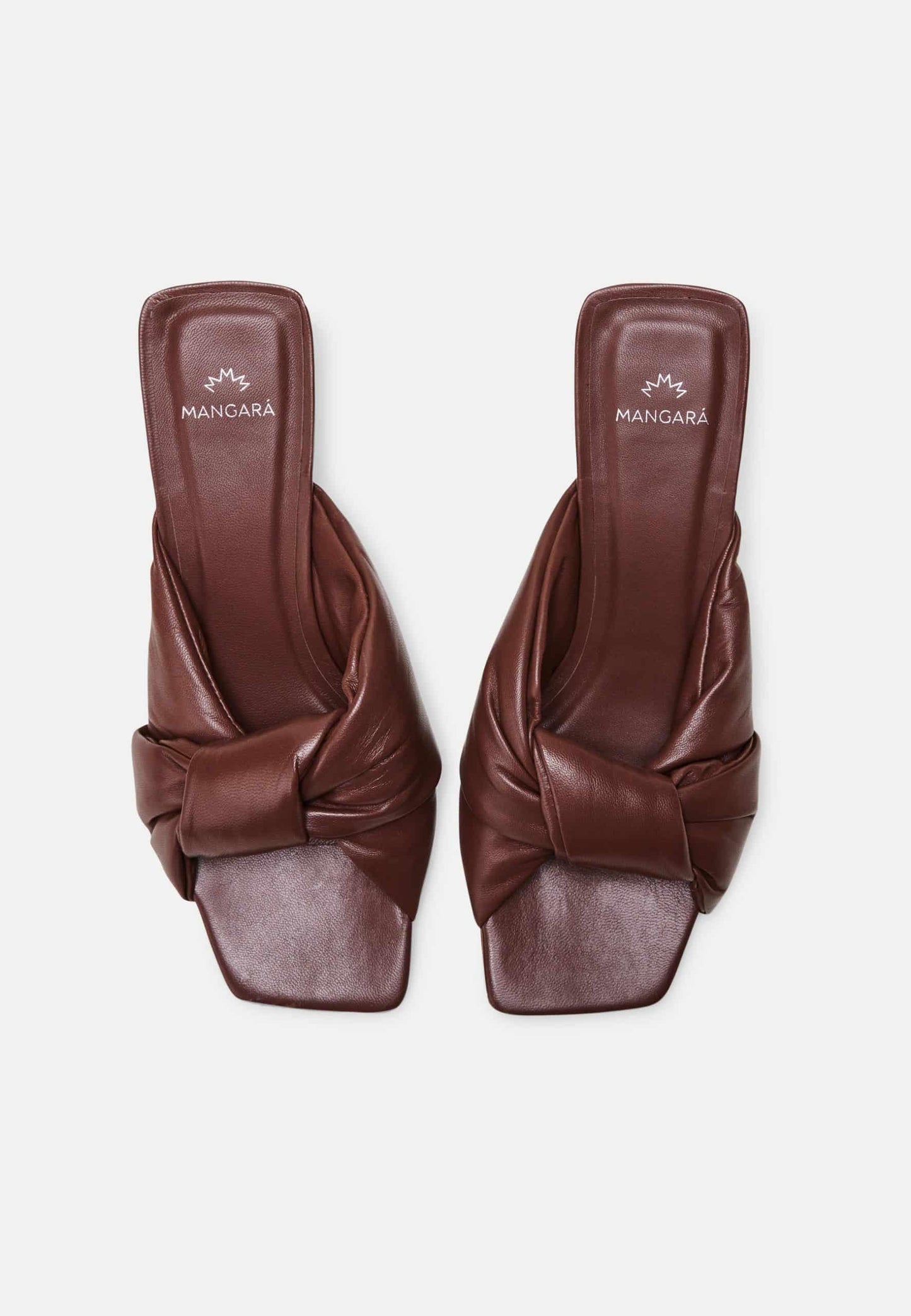 Pair of brown leather sandals with knotted design on a white background