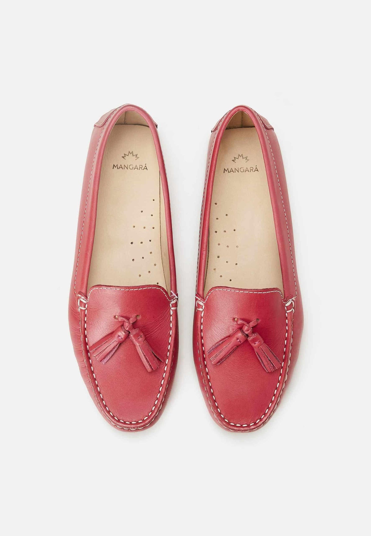 Pair of red loafers with tassels on a white background