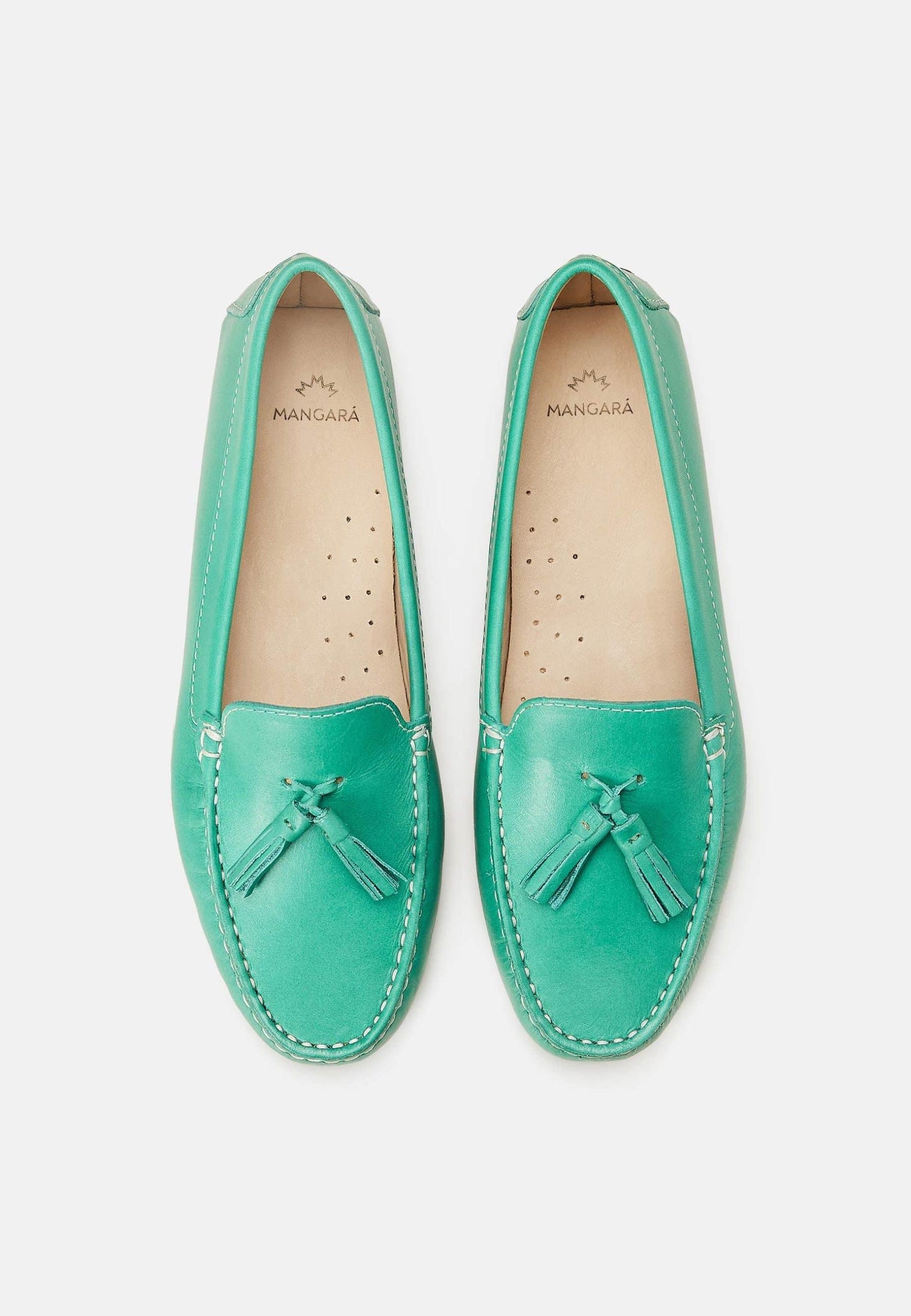 Pair of teal loafers with tassels on a white background