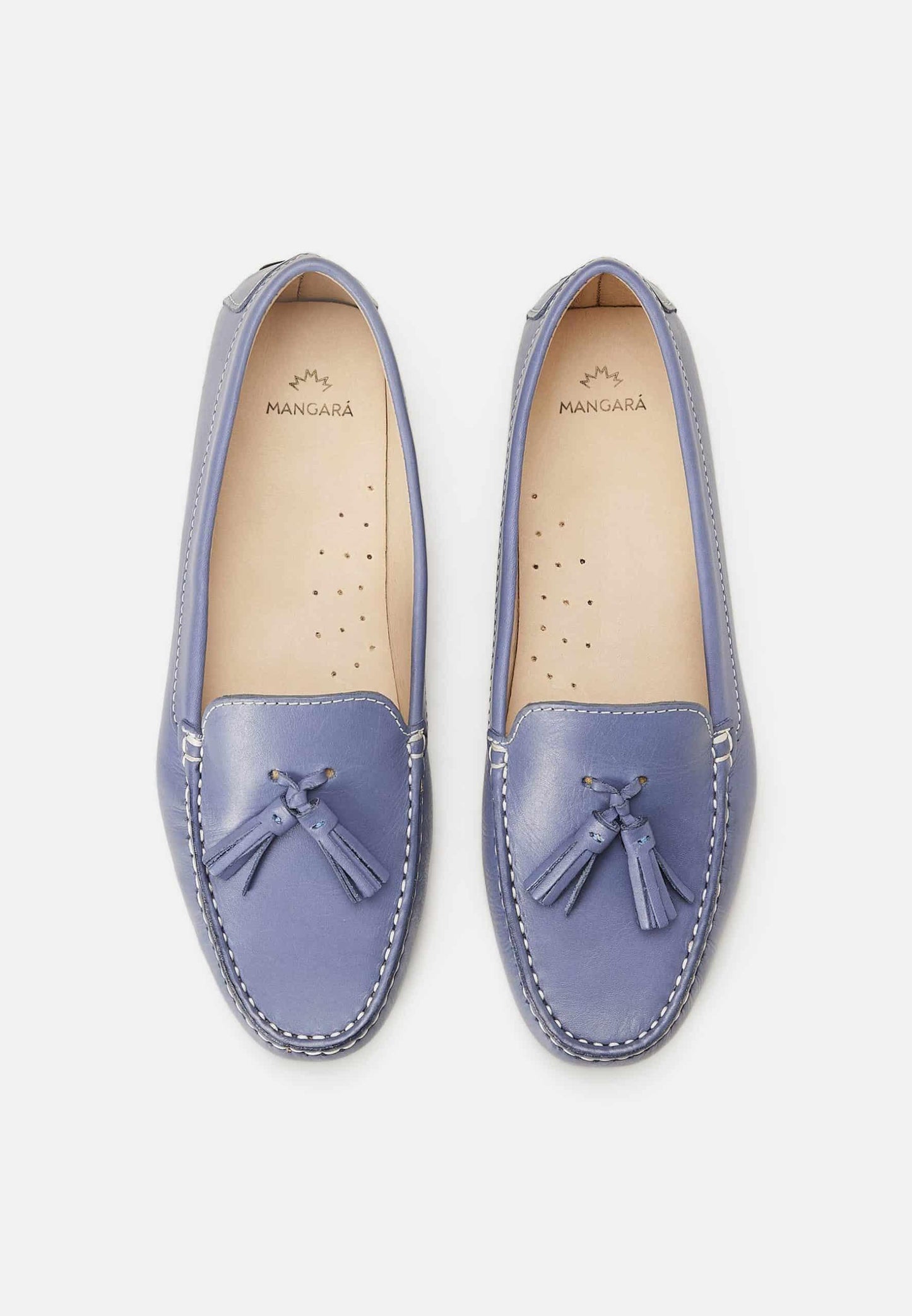 Pair of light blue loafers with tassels on a white background