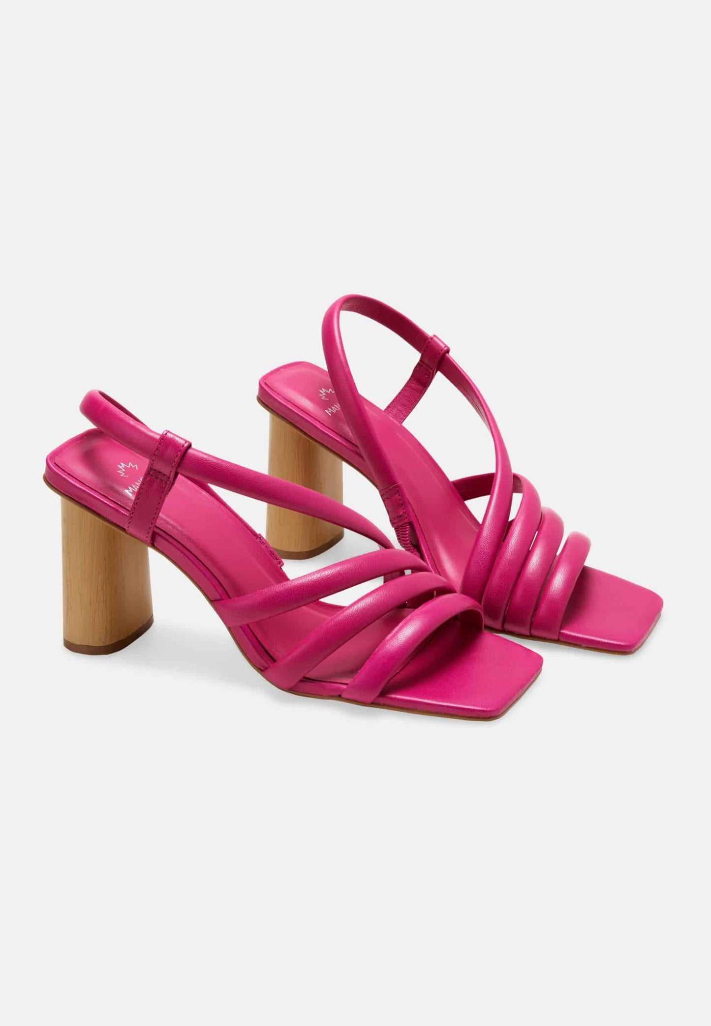 Pair of bright pink high-heeled sandals on a light gray background