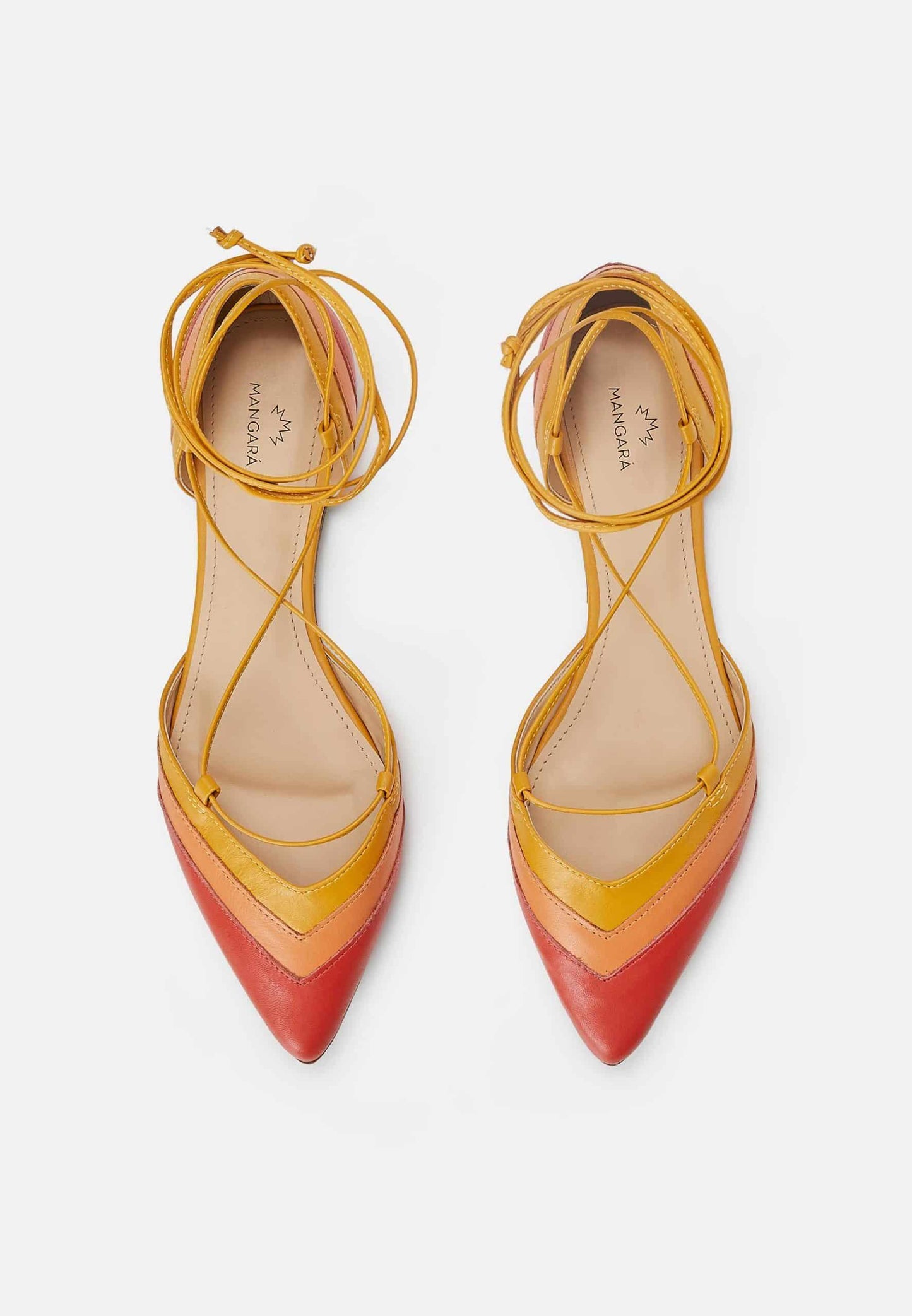 Pair of yellow and red pointed-toe shoes with strappy design on a white background
