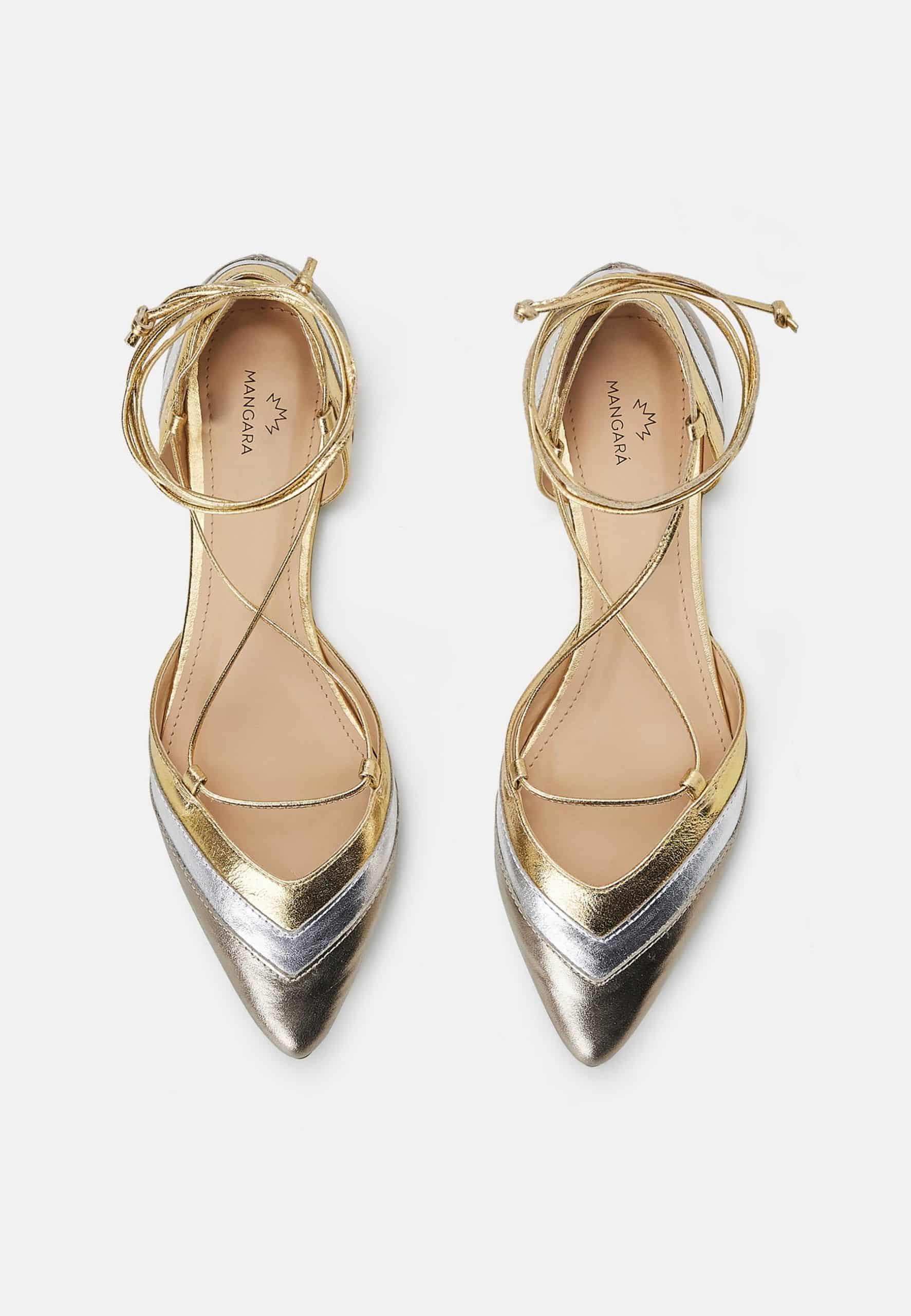 Gold and silver pointed-toe shoes on a white background