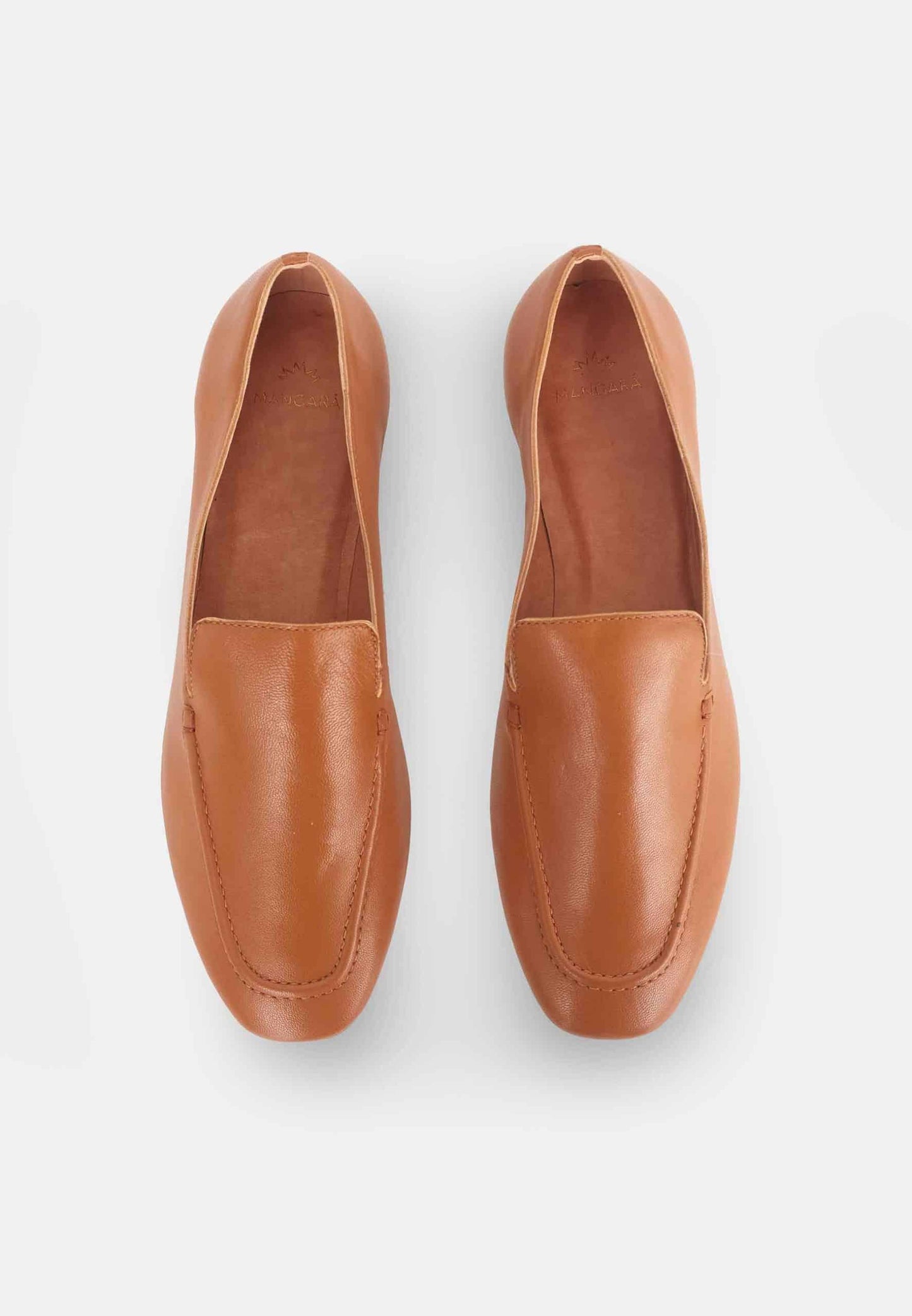 Pair of brown loafers on a light gray background