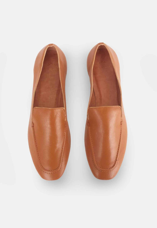 Pair of brown loafers on a light gray background