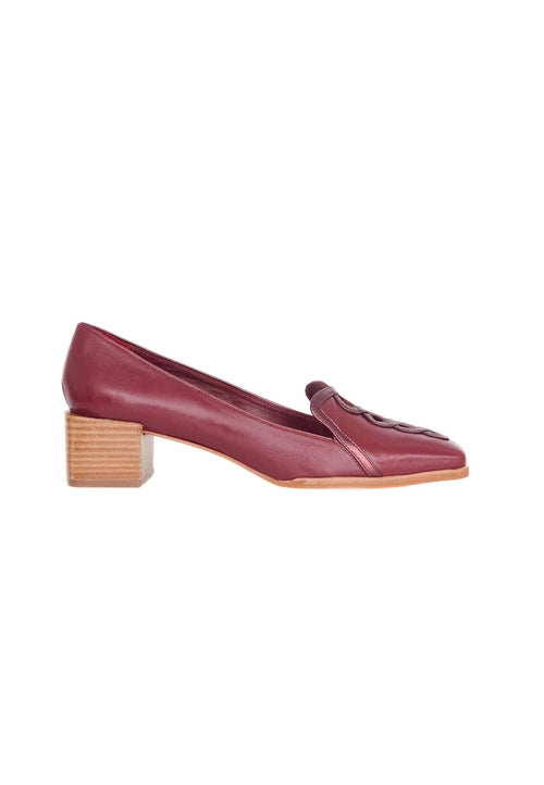 Maroon shoe with wooden block heel on a white background