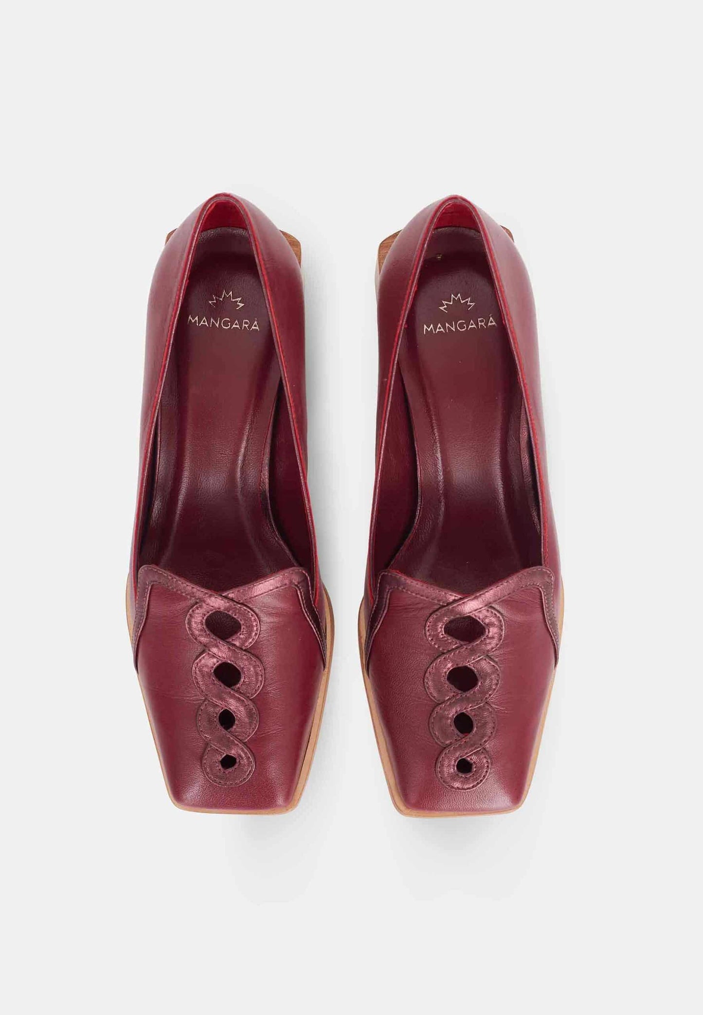 Pair of maroon high-heeled shoes with cut-out design on a white background