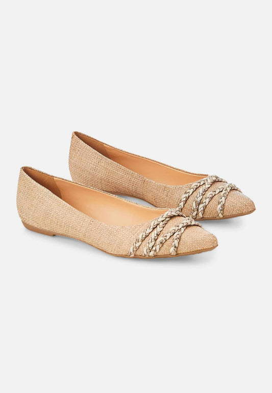 Pair of gold flats with decorative straps on a white background