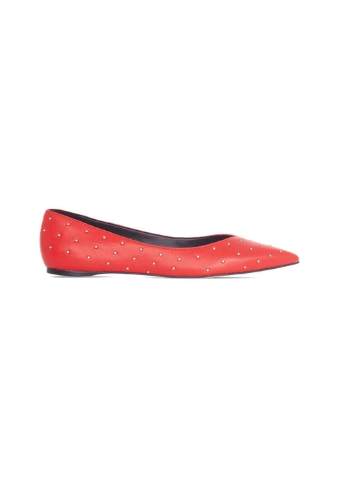 Red studded flat shoe on a white background