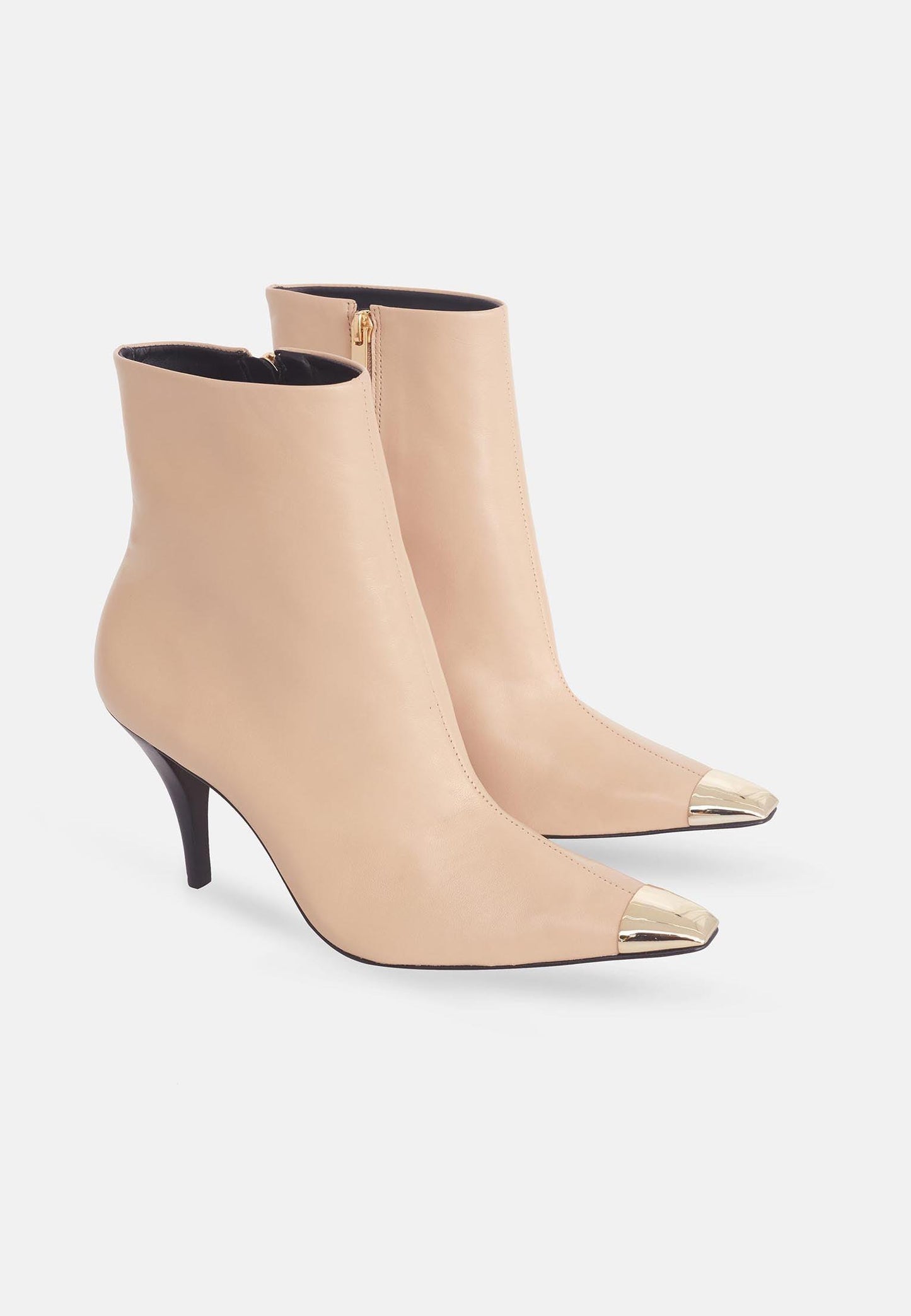 Beige high-heeled ankle boots with metallic toe on a white background