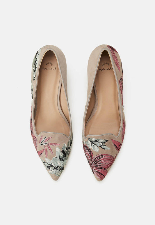 Pair of floral pointed-toe flats on a light gray background