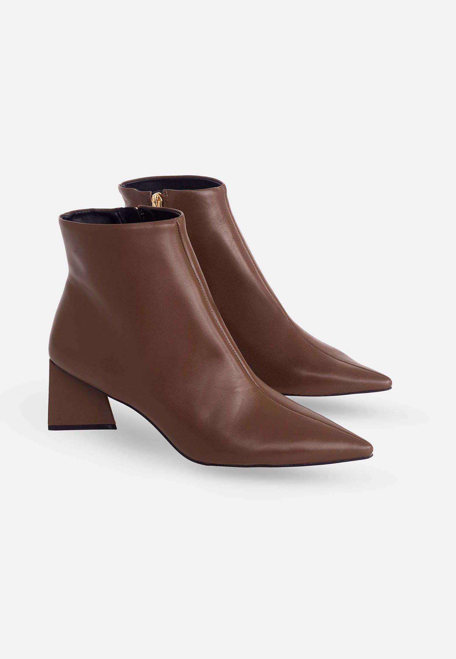 Pair of brown ankle boots on a white background