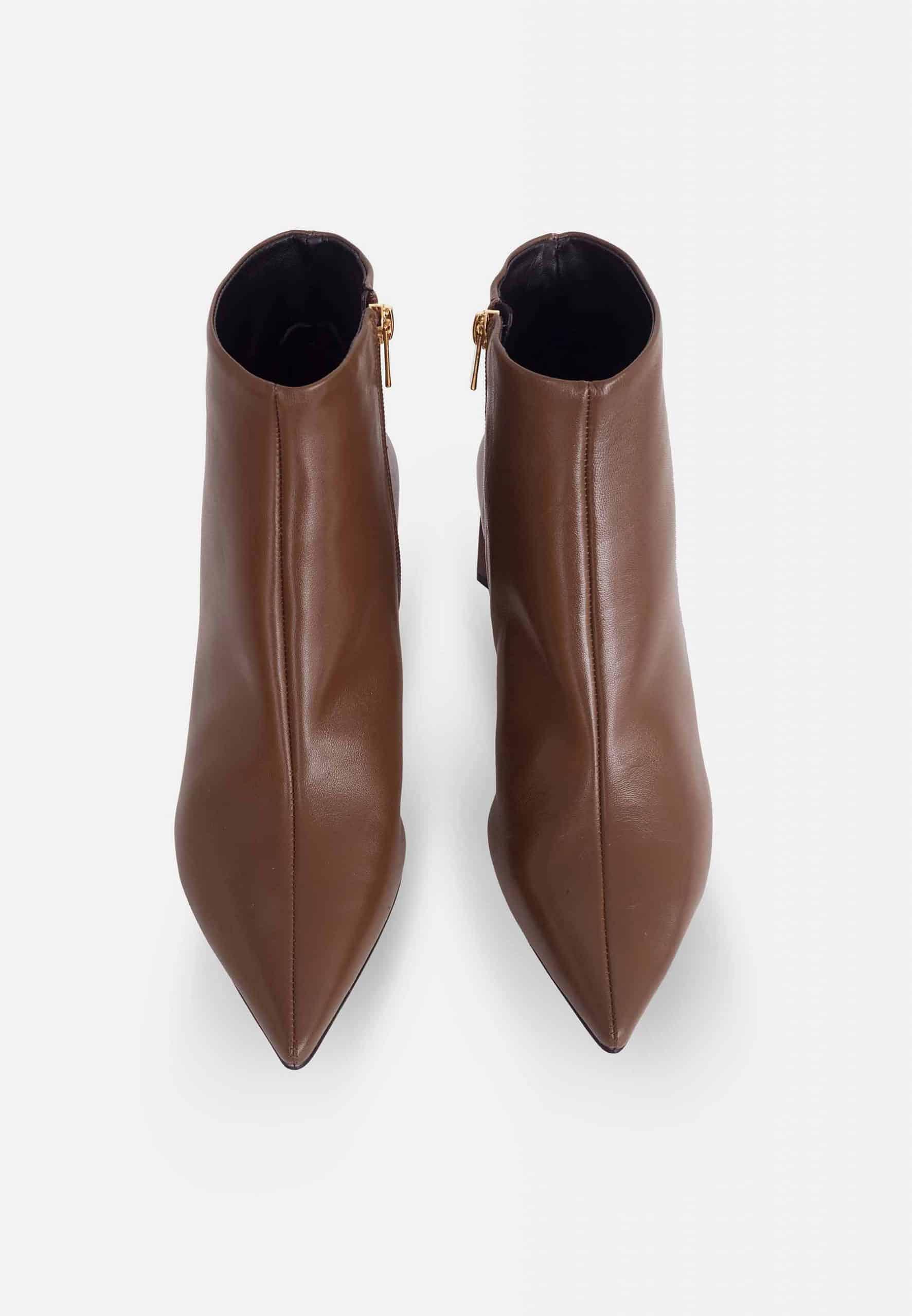 Pair of brown ankle boots on a white background