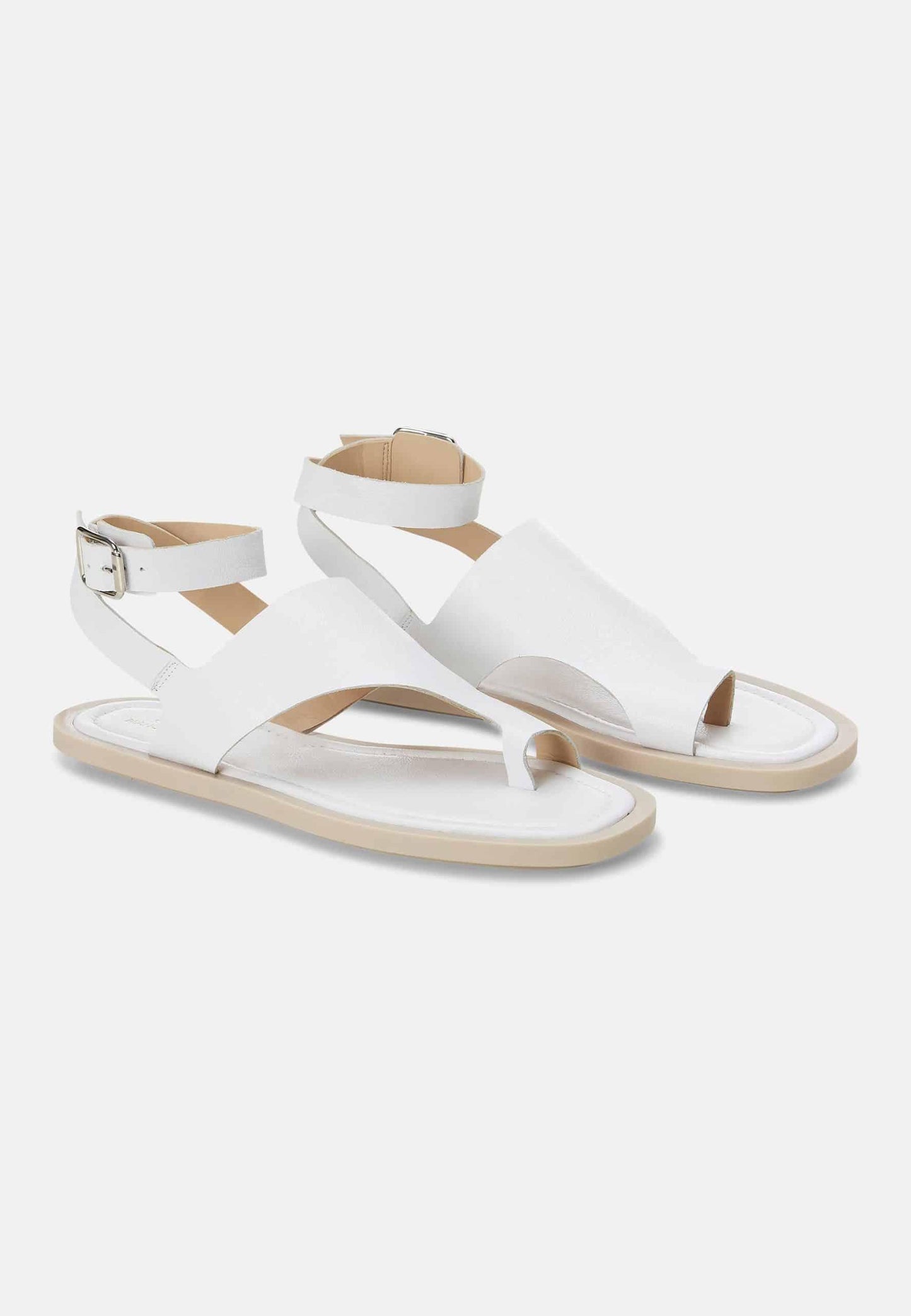 White sandals with thin straps on a white background