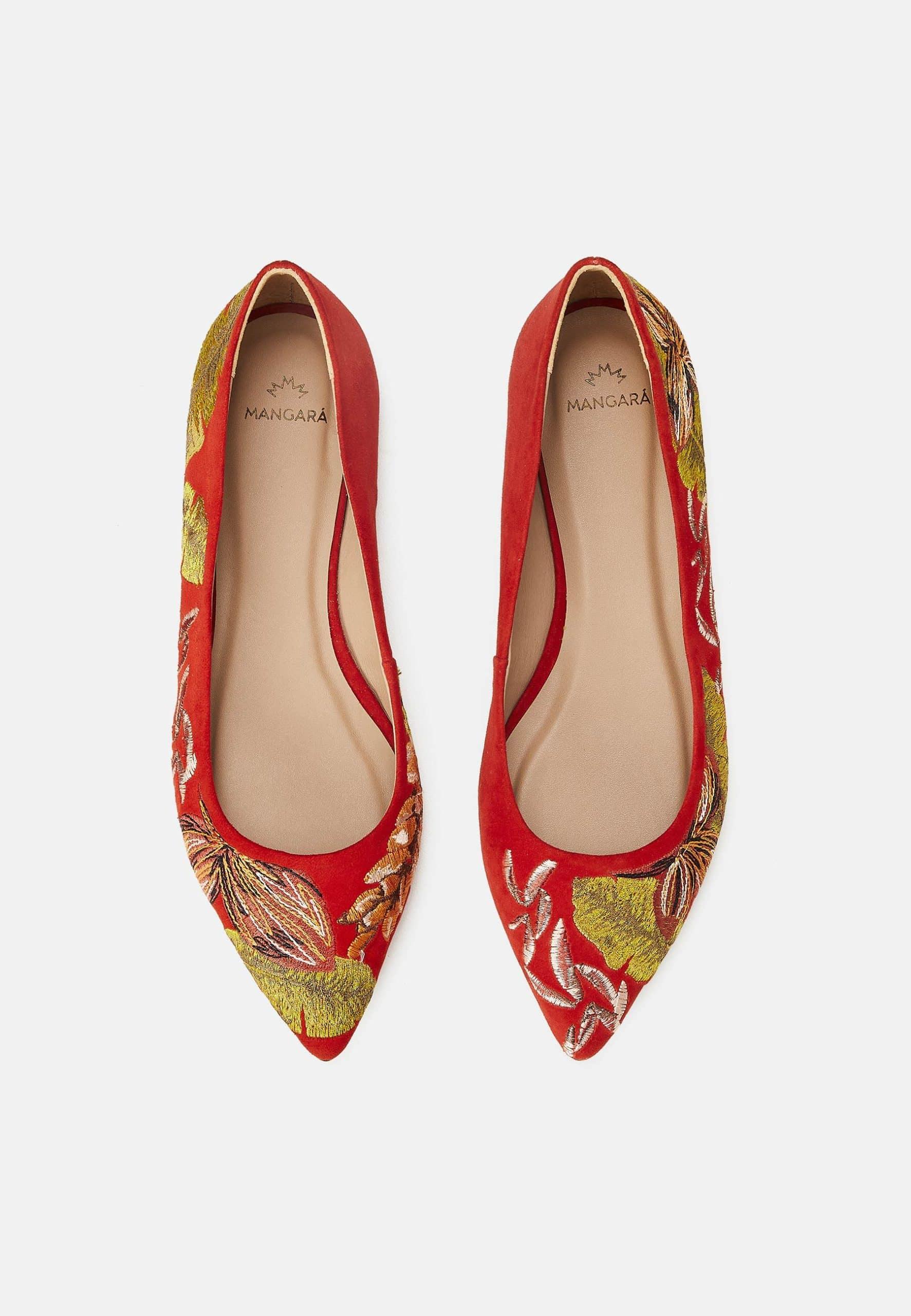 Red pointed-toe shoes with floral pattern on a white background