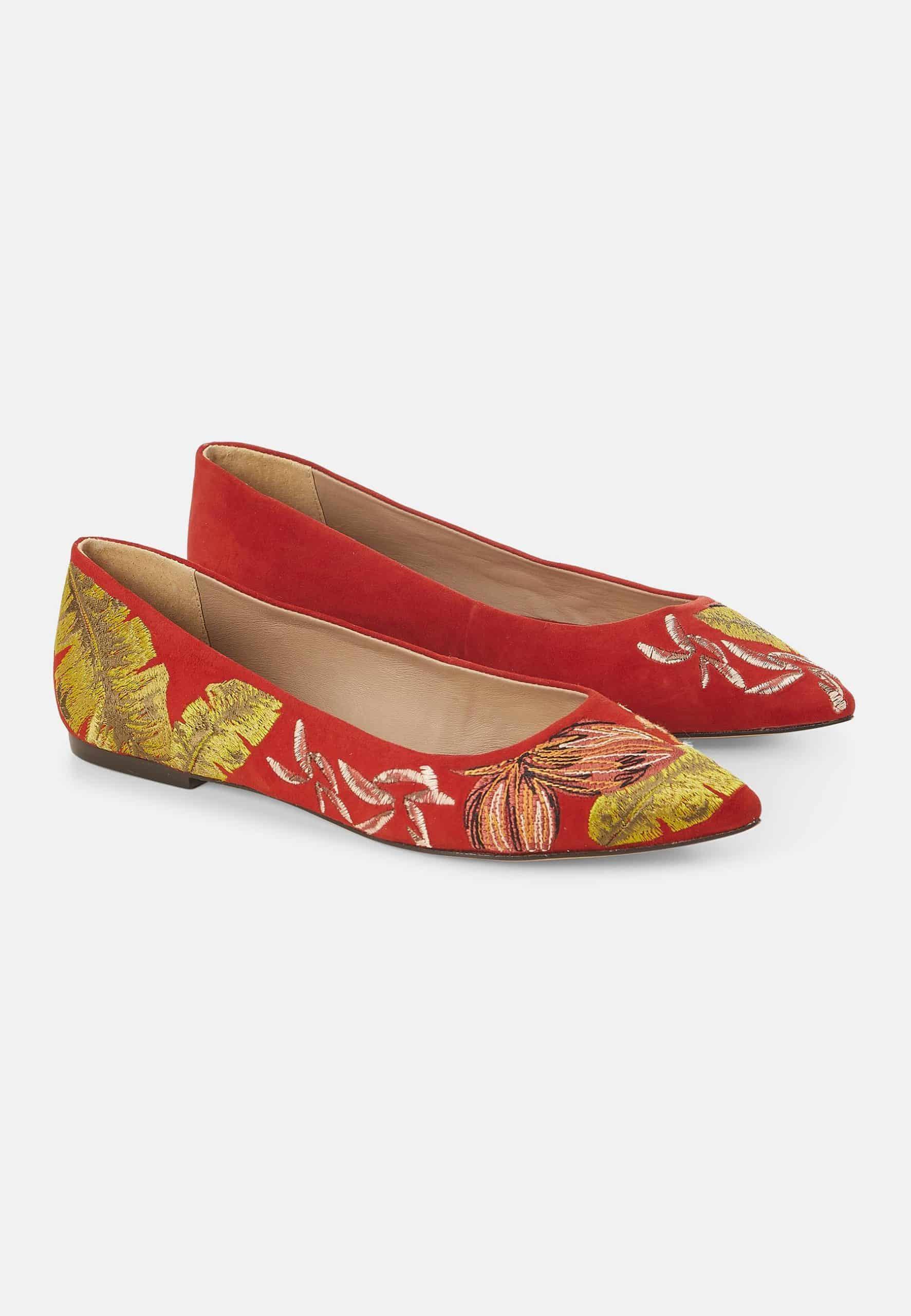 Red flats with floral embroidery on a white background