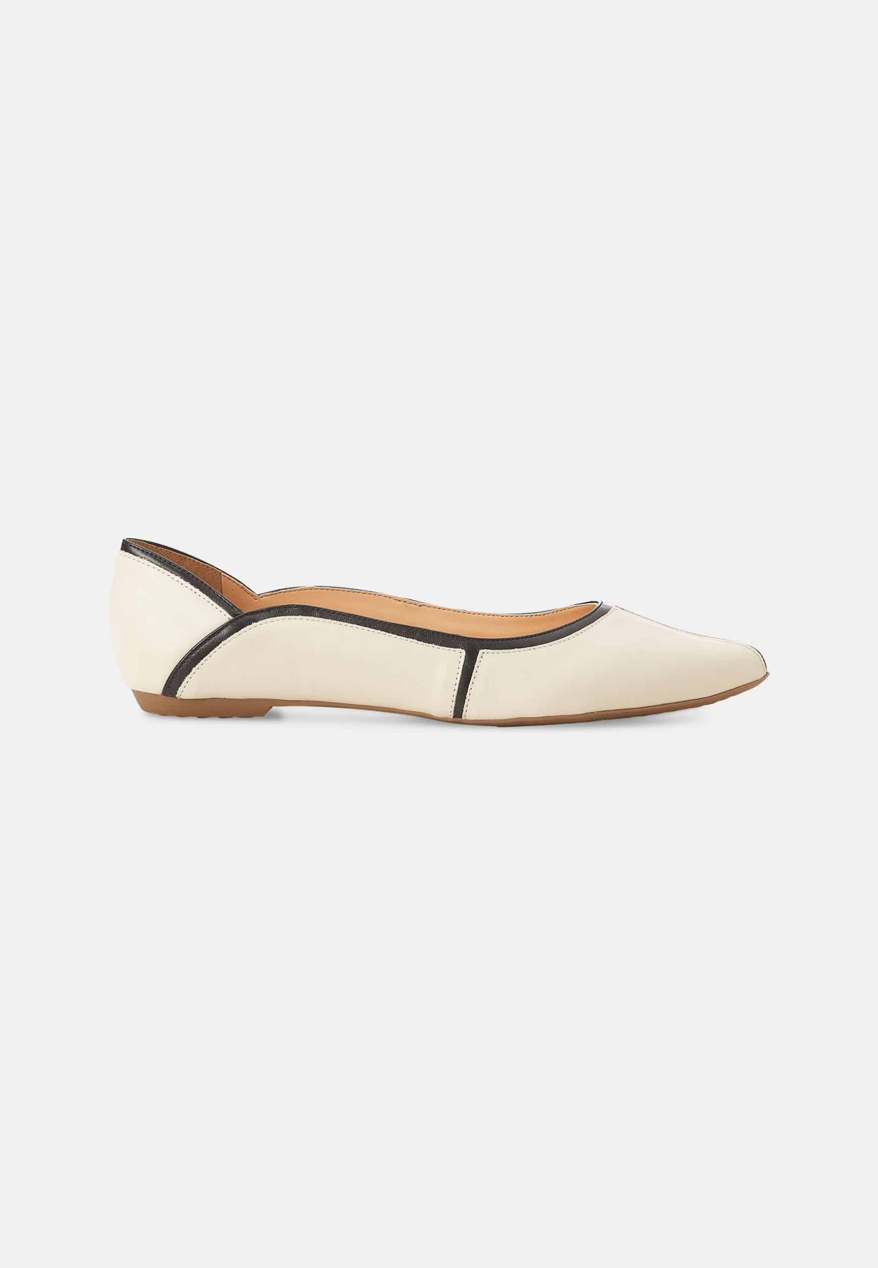 White flat shoe with brown accents on a white background